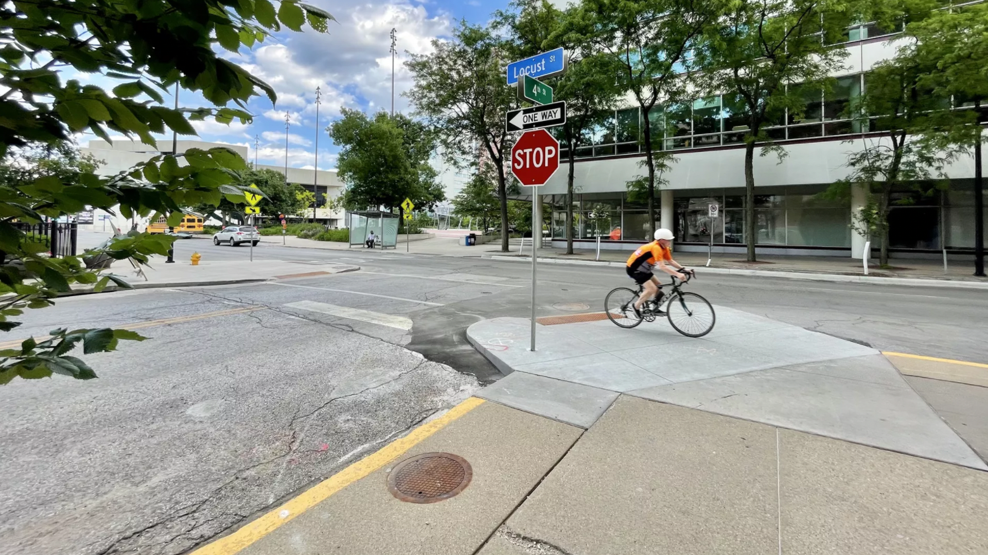 A bicyclist riding by a bumpout near the corner of 4th and Locust streets in Des Moines.