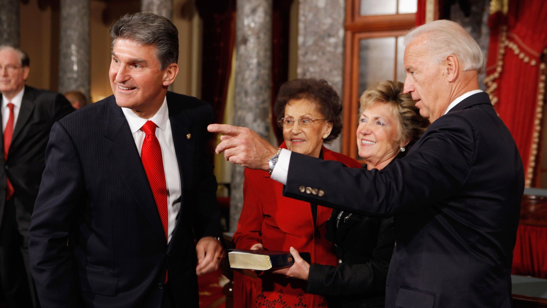 Sen. Joe Manchin looks behind him during swearing in ceremony.