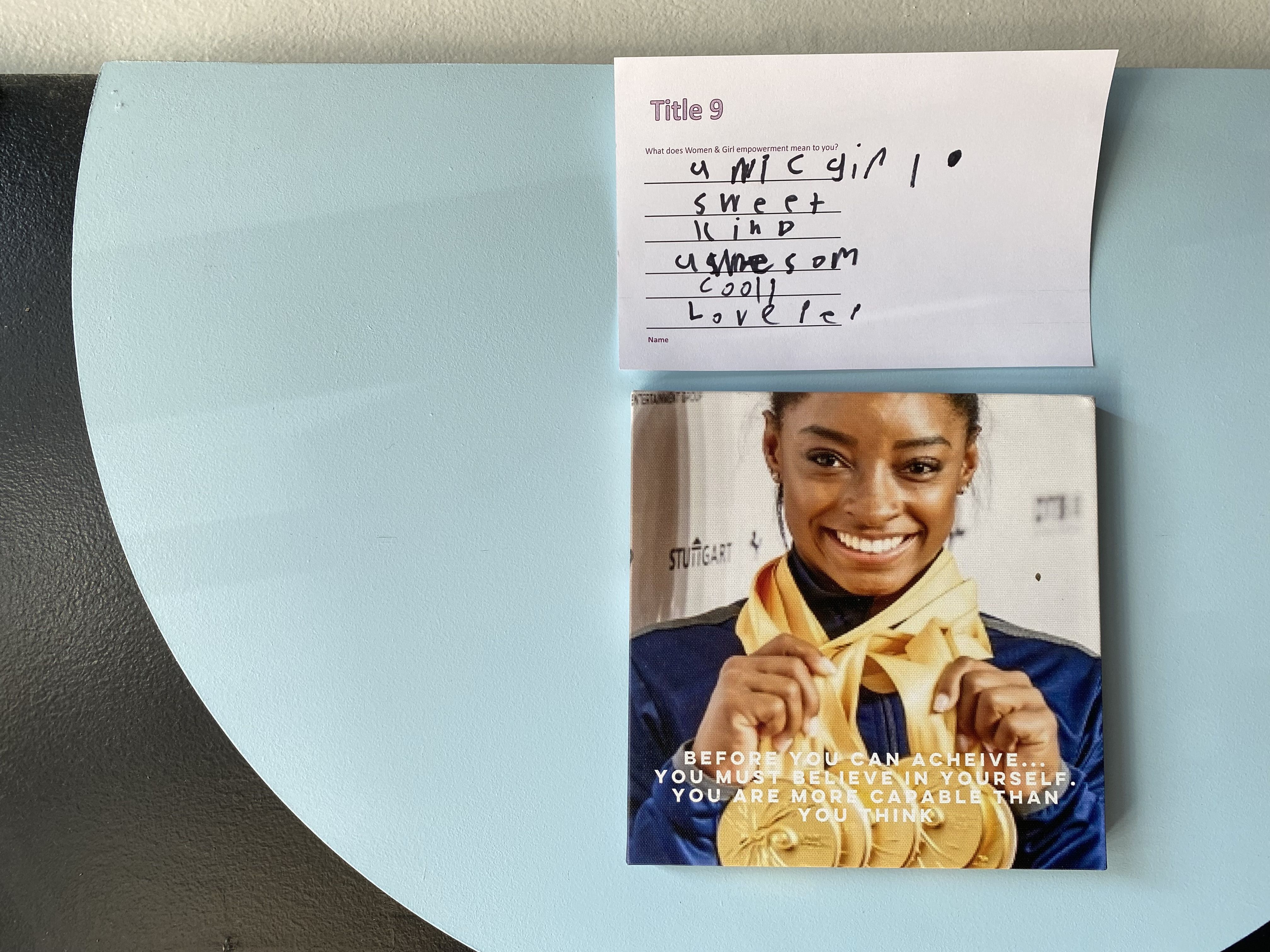A note from a visitor next to a photo of Simone Biles.