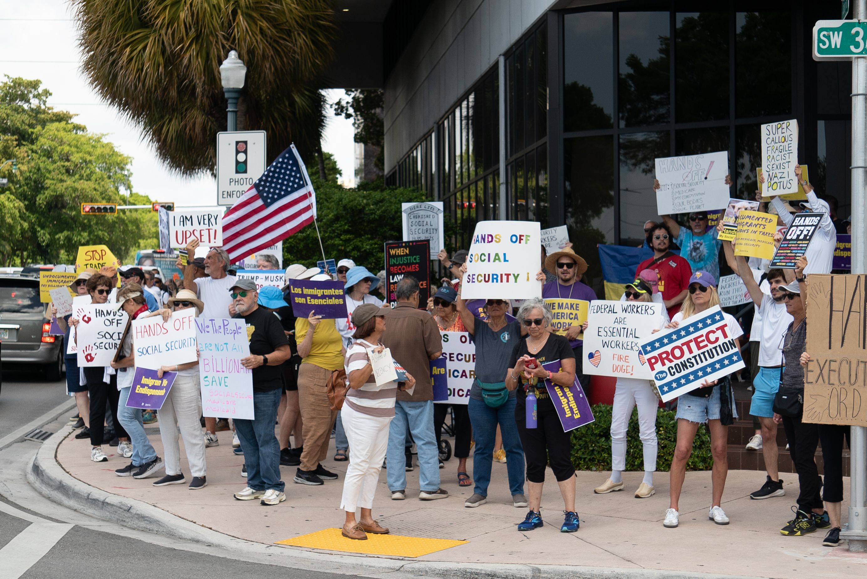 Protesters with signs on a street corner 
