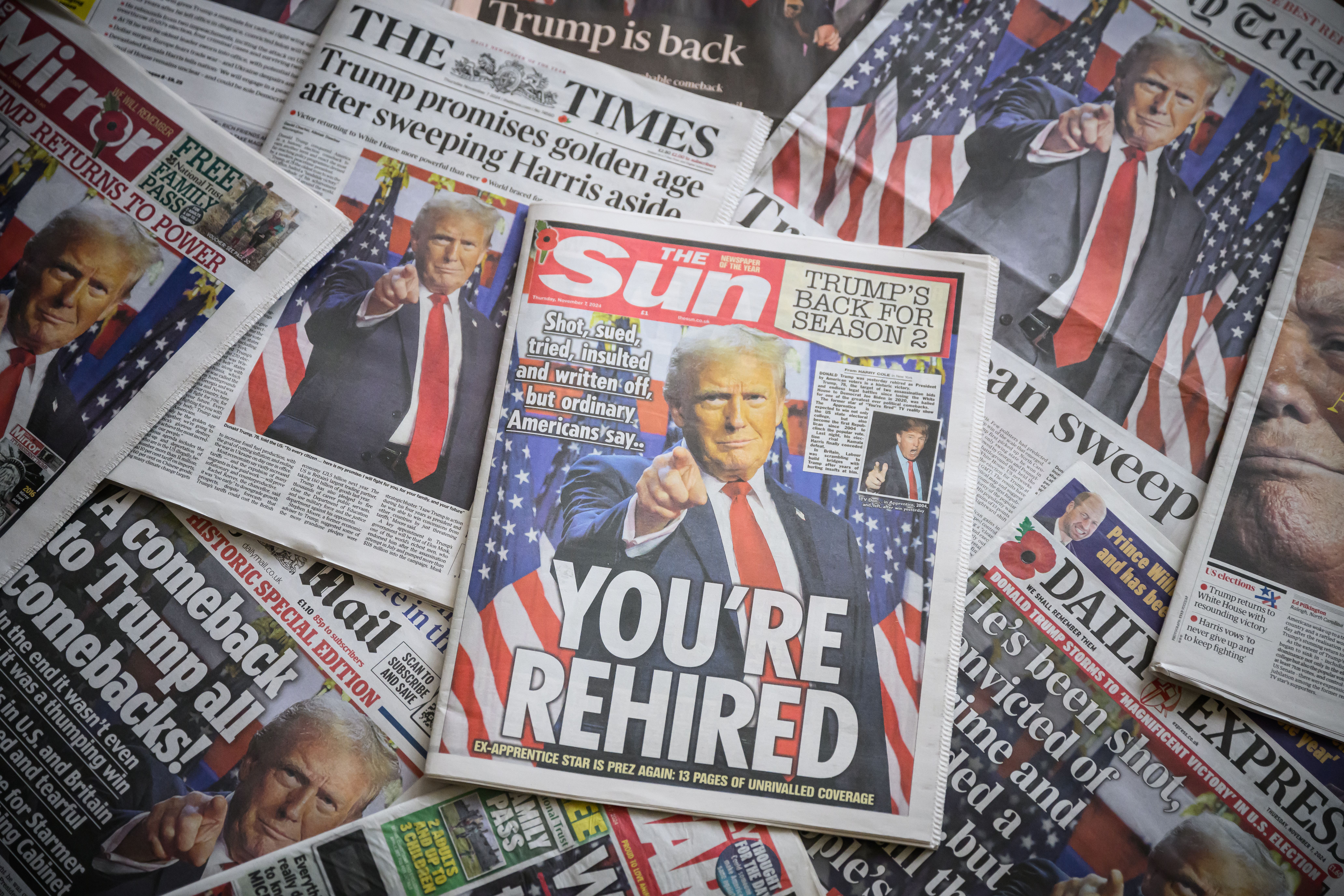 LONDON, ENGLAND - NOVEMBER 07: In this photo illustration, UK newspaper front pages display stories on the re-election of former US President Donald Trump on November 07, 2024 in London, England. Republican Donald Trump has won a second term to become the 47th President of the United States of Ameri