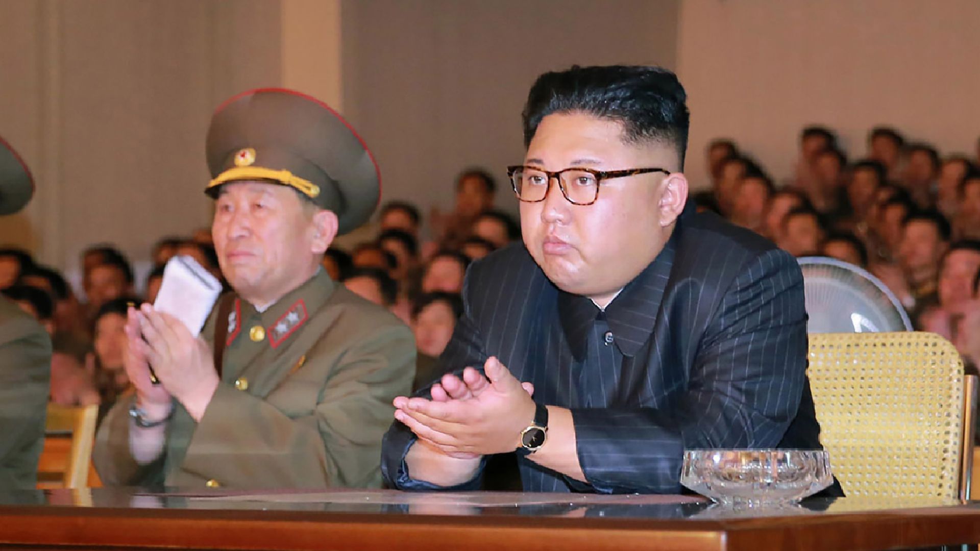 North Korean leader Kim Jong-Un (C) clapping hands while viewing a stage during his inspecting the Command of the Strategic Force of the Korean People's Army