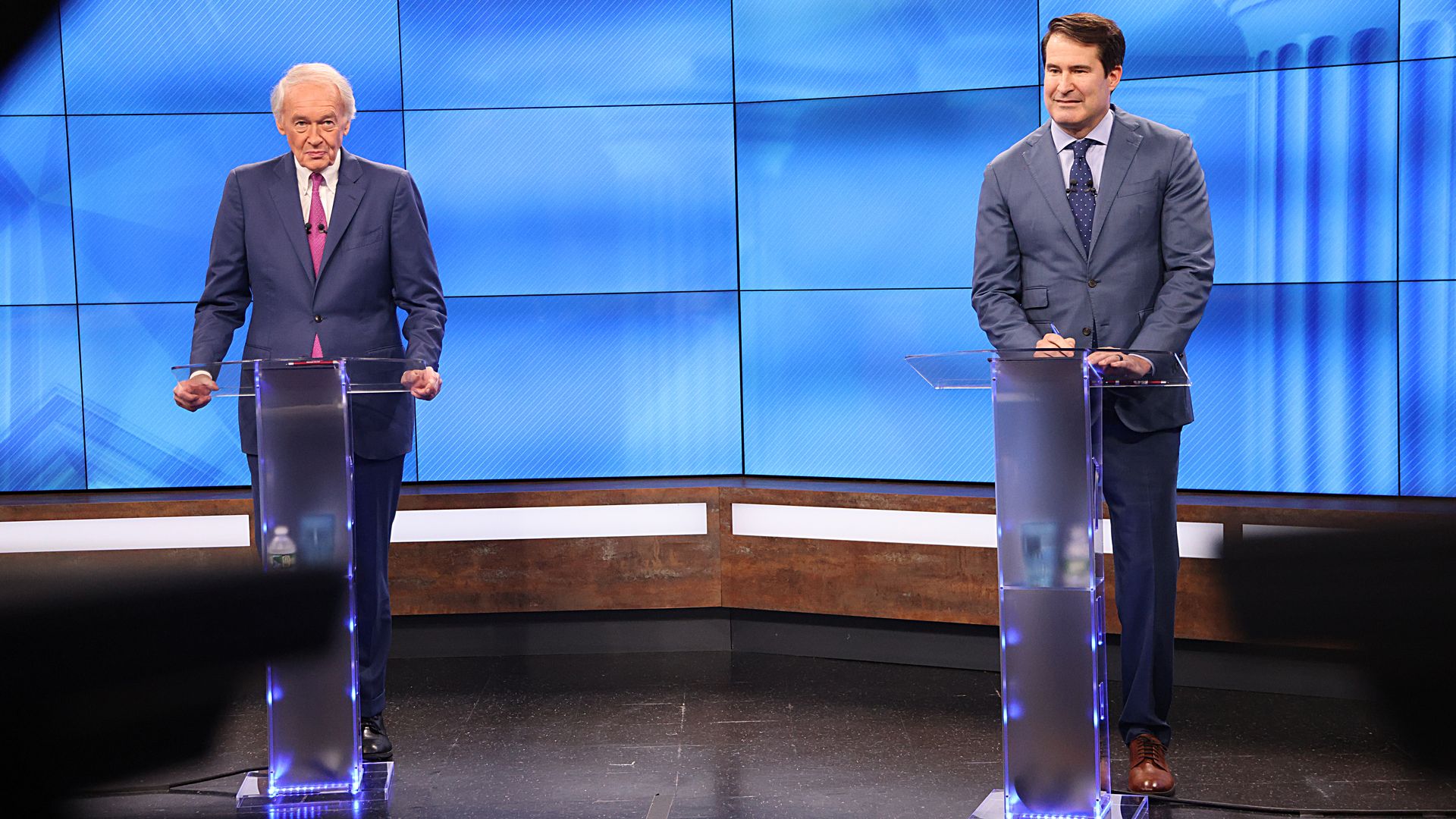 Sen. Ed Markey and Rep. Seth Moulton stand behind lecterns before a debate at WWLP-22News in Chicopee, Mass.
