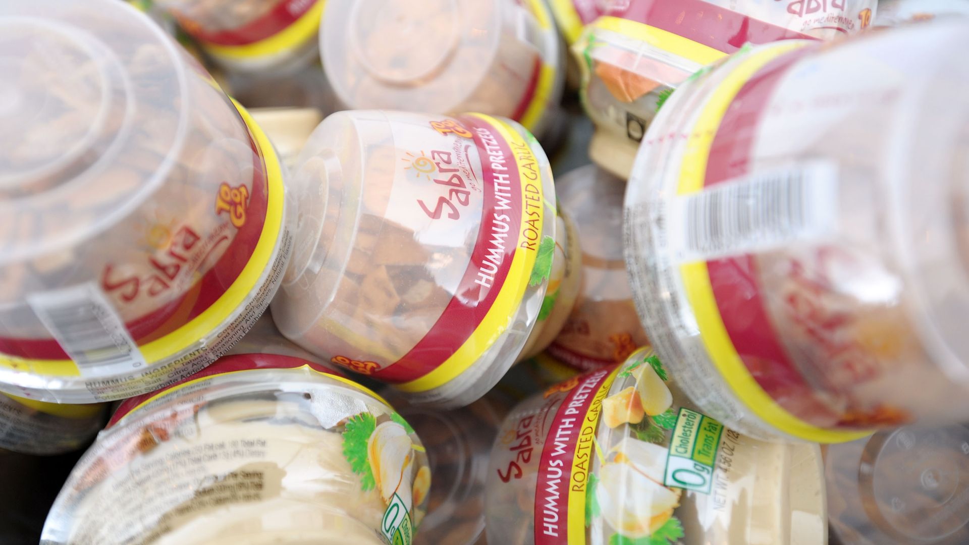 A pile of hummus and pretzel cups.