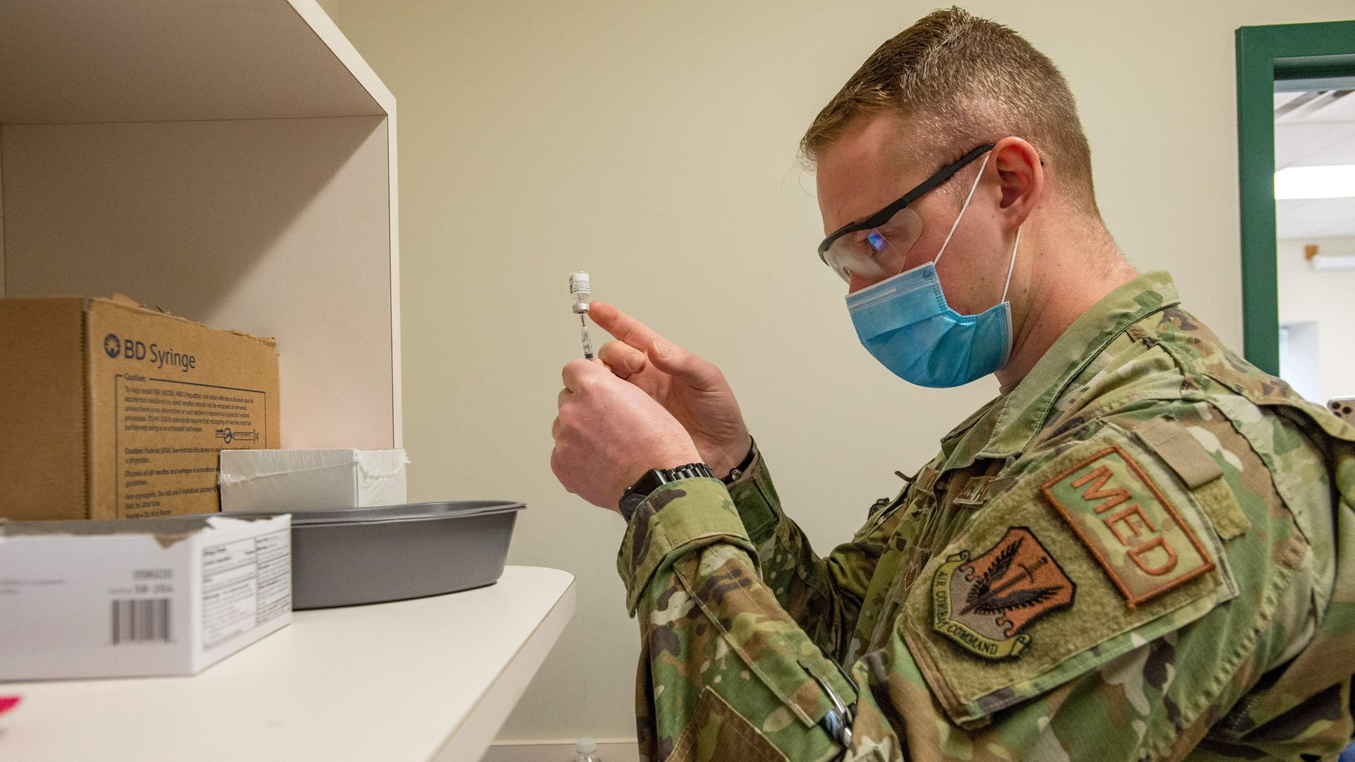 A U.S. Air Force Airman preparing a dose of coronavirus vaccine at a vaccination clinic in Boston in February 2021.
