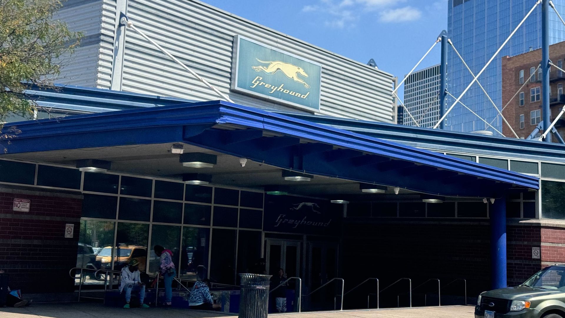 A bus station with a greyhound sign.
