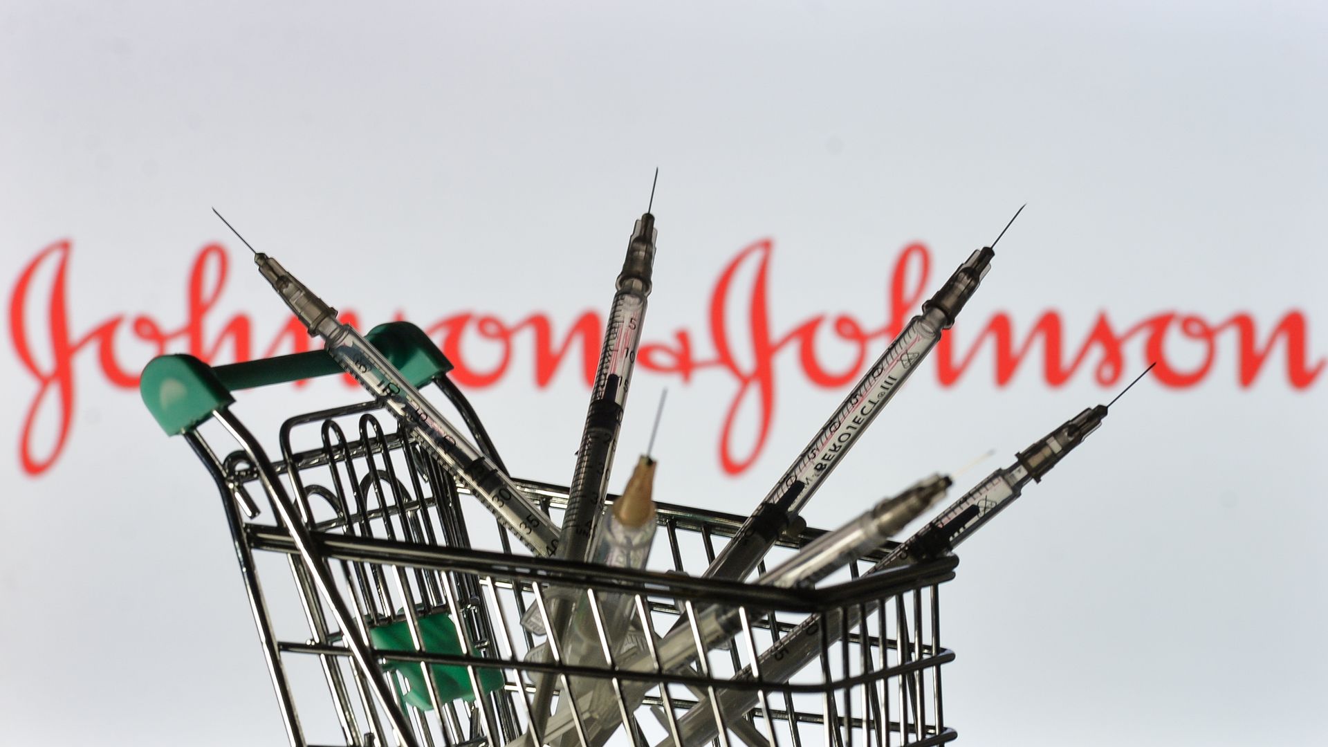 Image of syringes in front of the Johnson and Johnson logo.