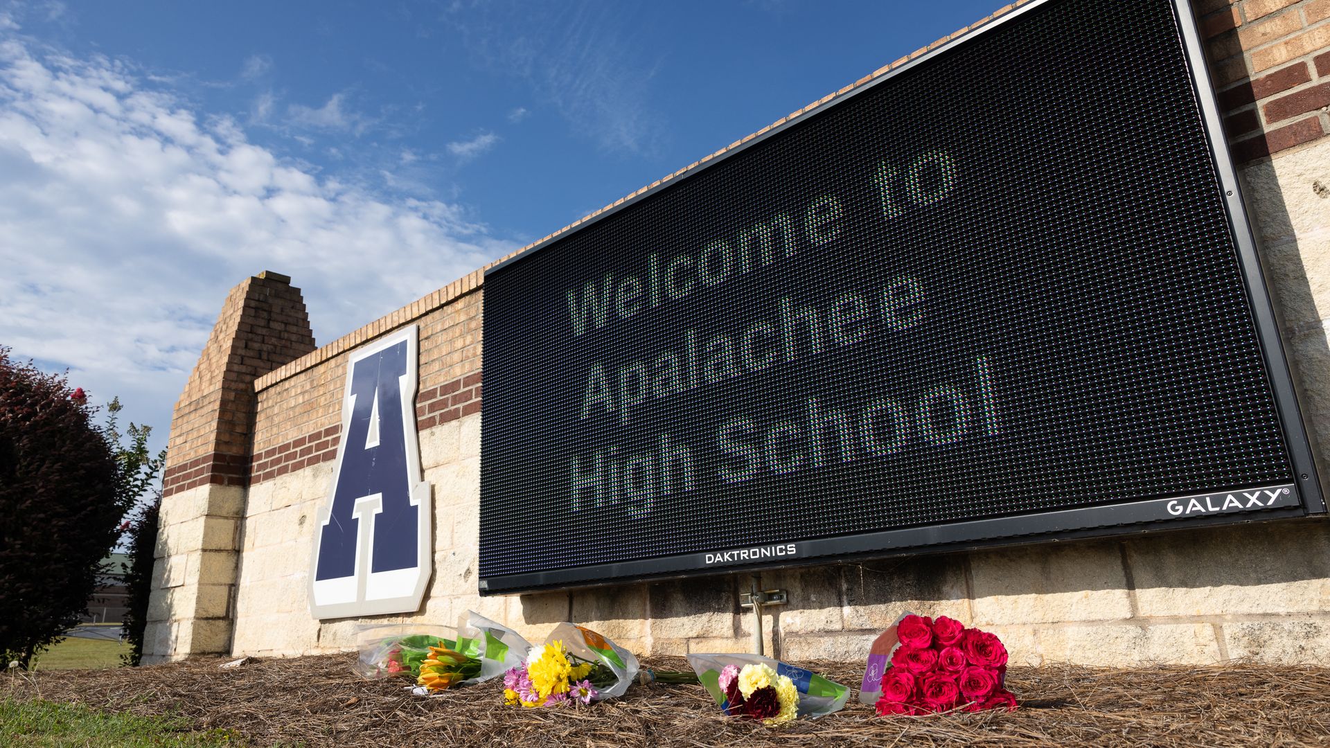 Flowers lay in front of the school sign outside of Apalachee High School on September 5, 2024 in Winder, Georgia.