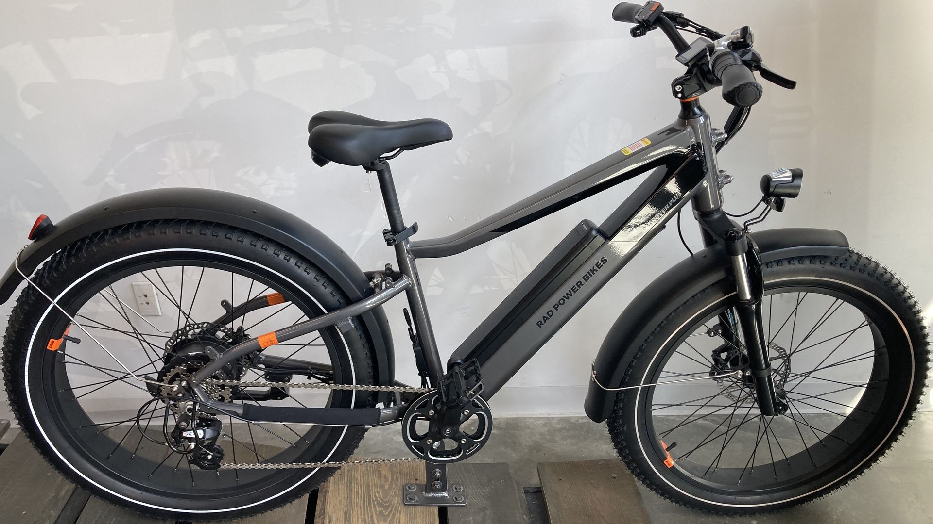 An electric bike with fat tires and tall handlebars. 