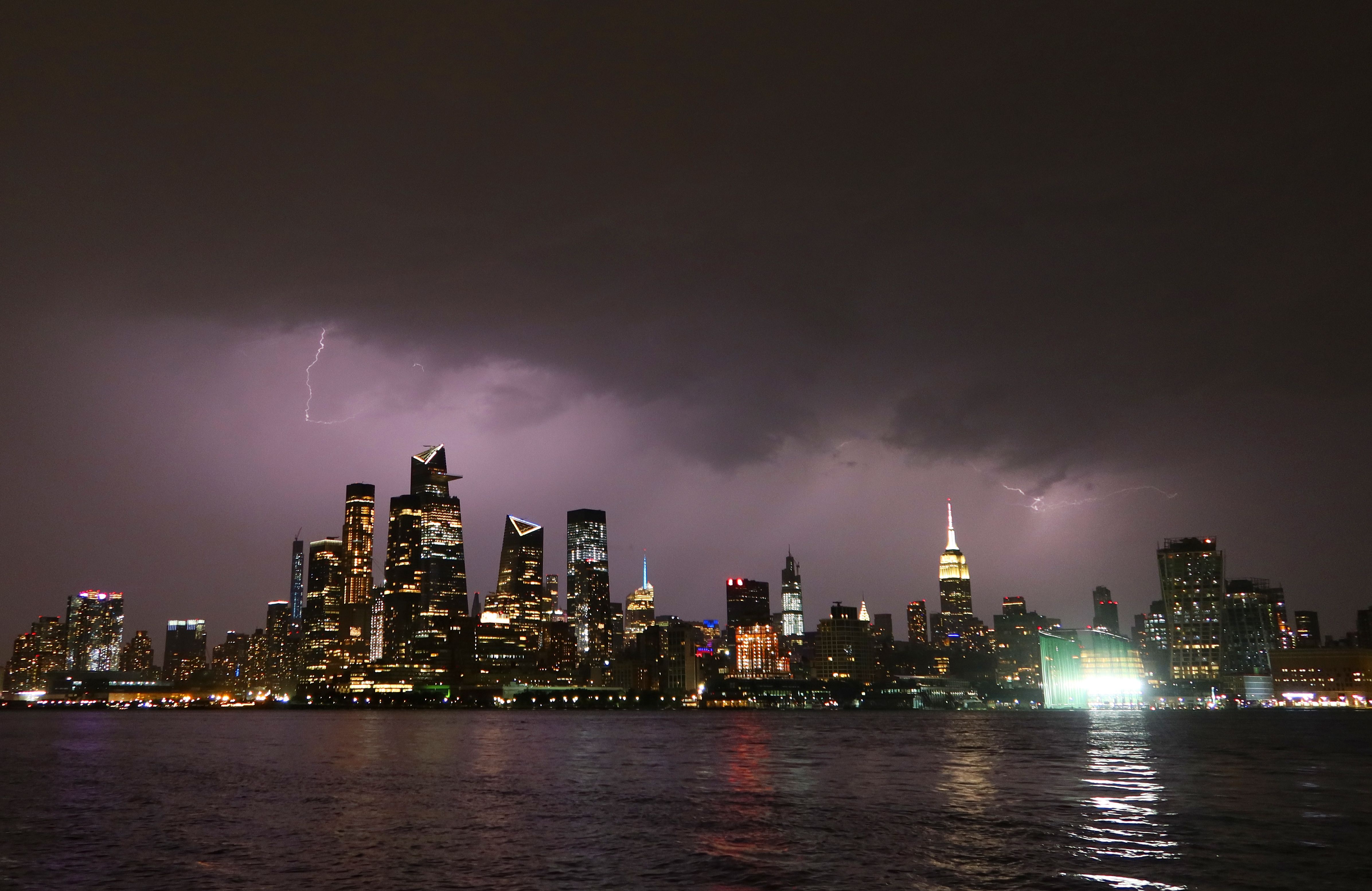  Lightning lights up the sky behind midtown Manhattan and the Empire State Building ahead of the expected arrival of Hurricane Isaias in the New York City area on August 3