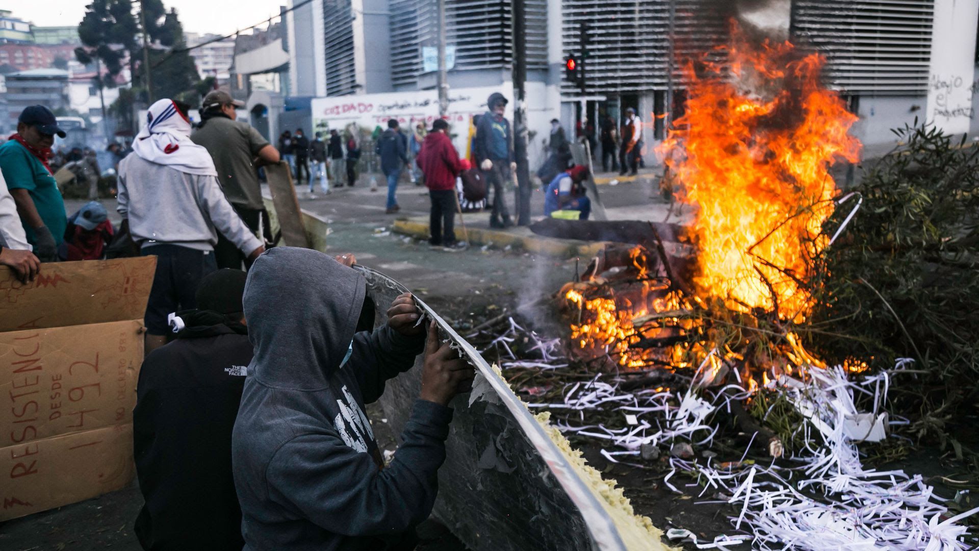 Protestors watching a fire burn in Ecuador