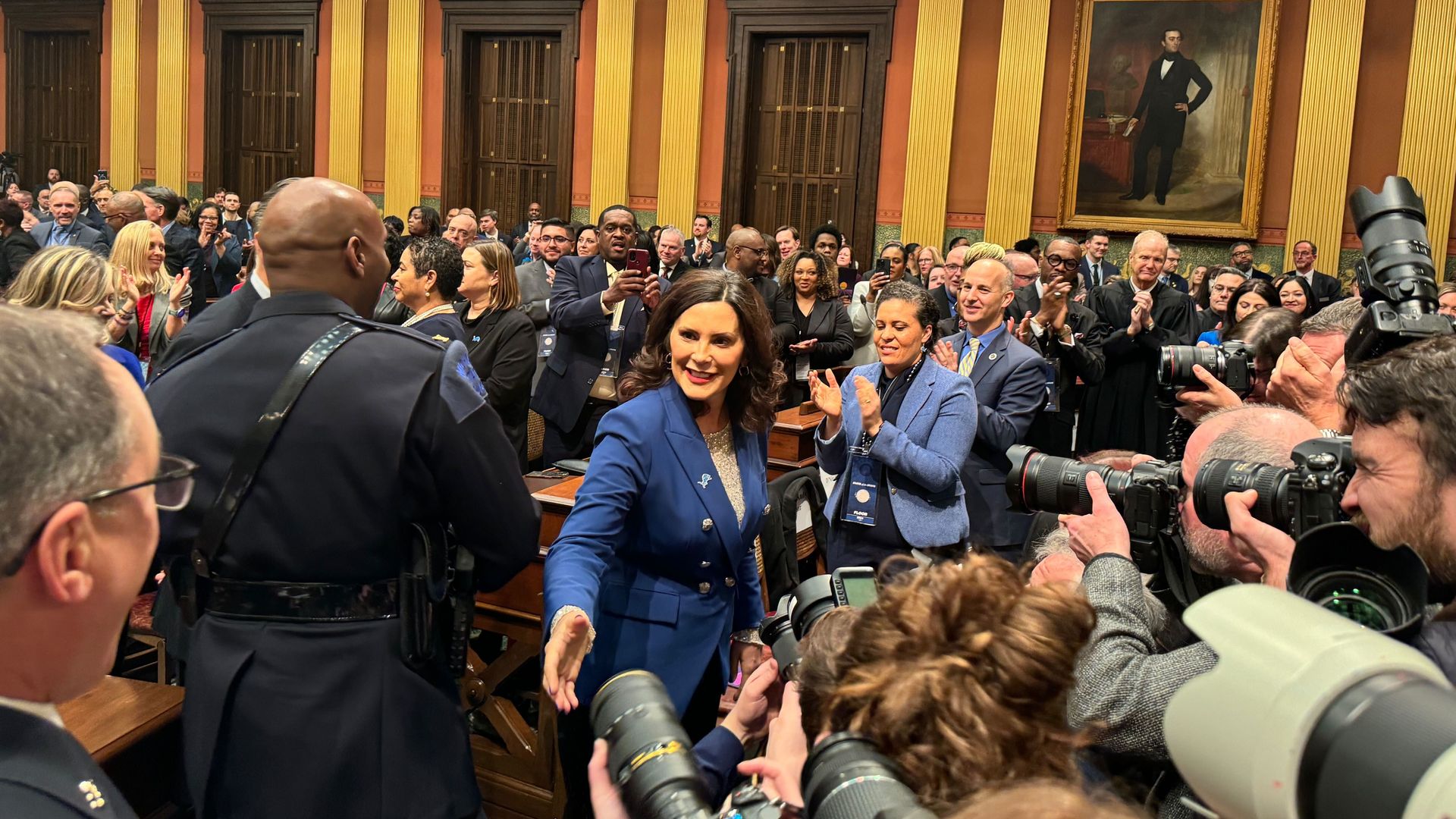 Whitmer smiles near cameras in the capitol building