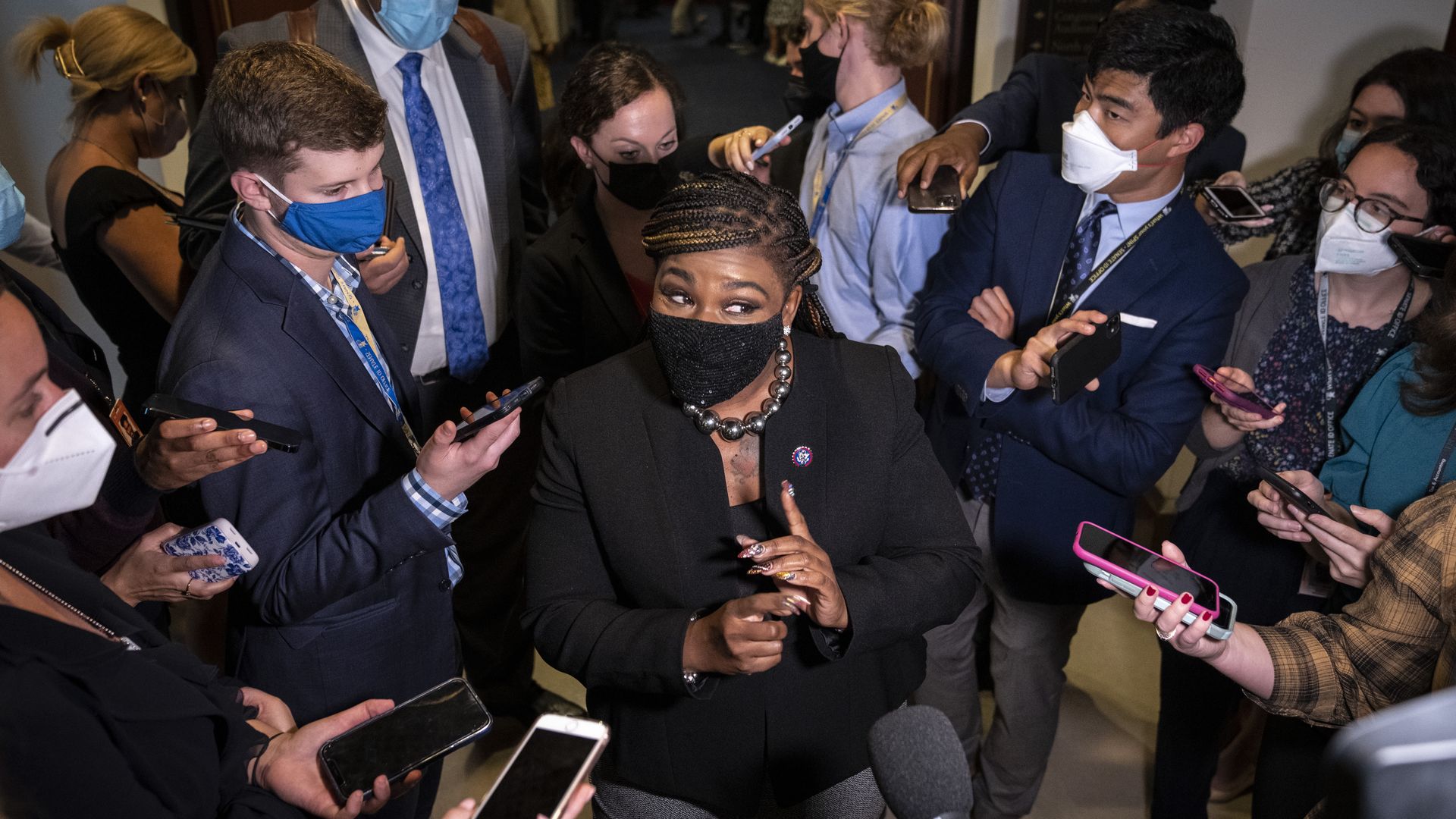 Rep. Cori Bush is seen surrounded by reporters on Thursday.