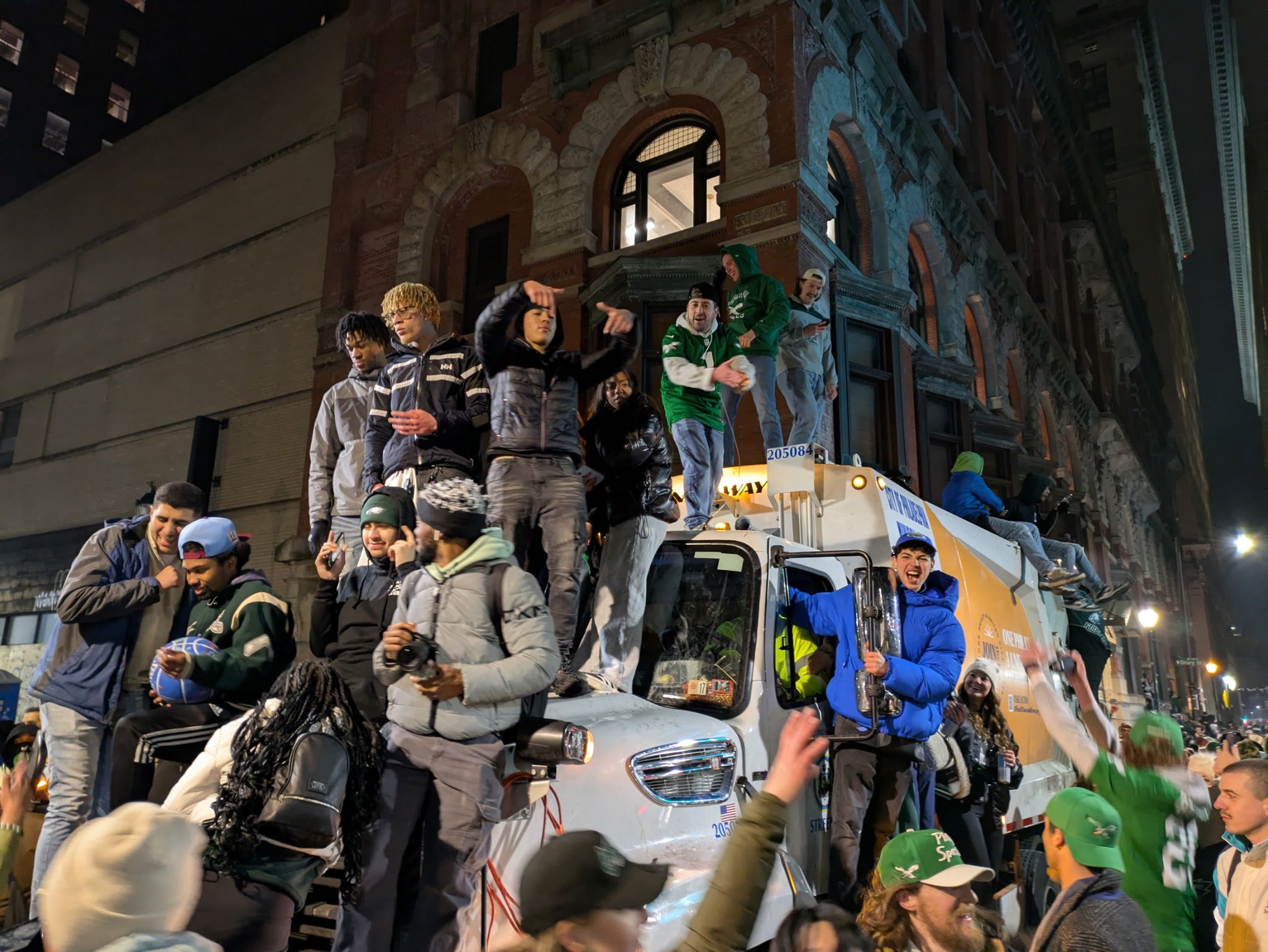 Fans climb trucks used to block off traffic.