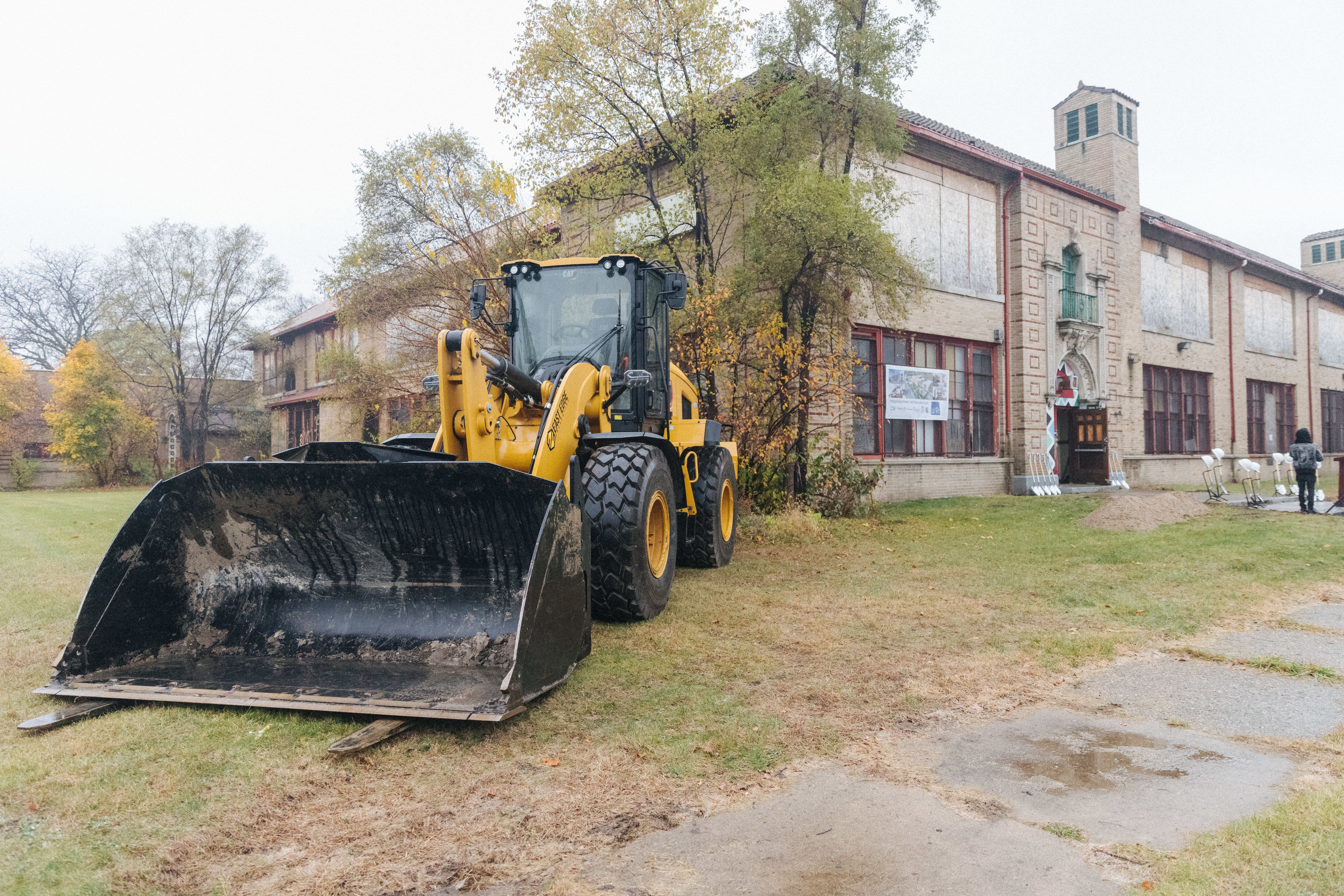The school shown with a bulldozer in front.