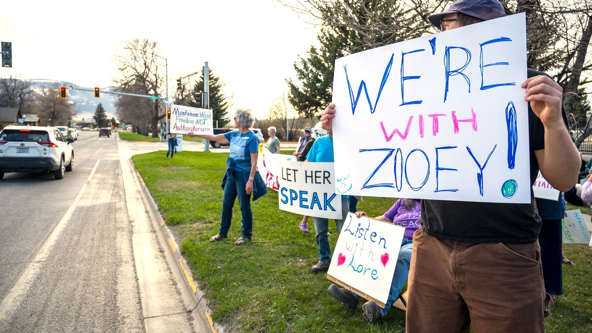 Supporters hold signs near a rally in support of transgender lawmaker Zooey Zephyr on April 29.