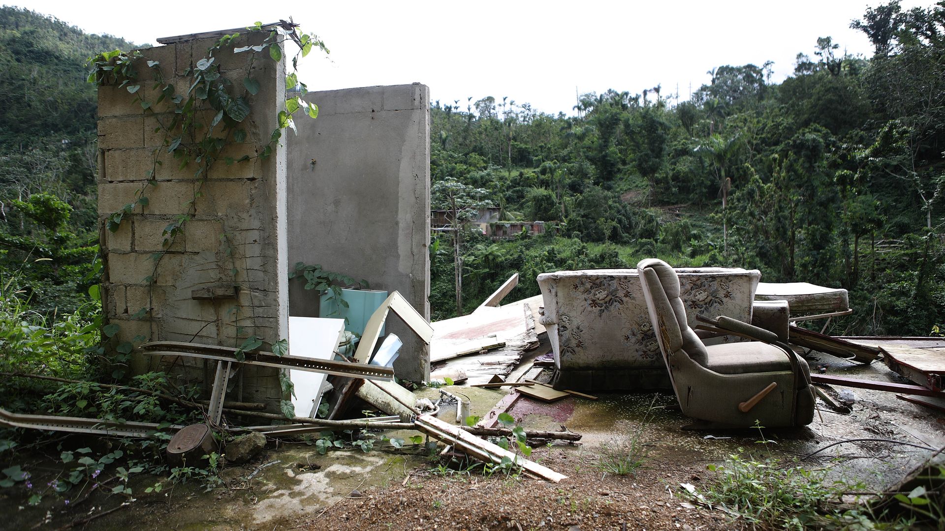 Forlorn couch sits amongst a ruined house