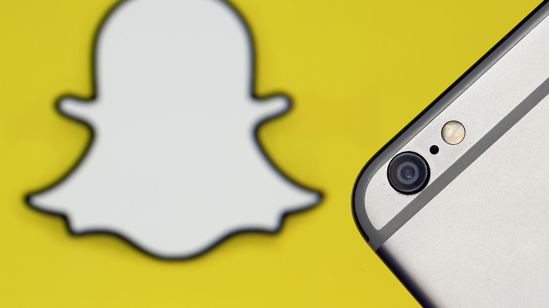 iPhone camera in front of the Snapchat logo