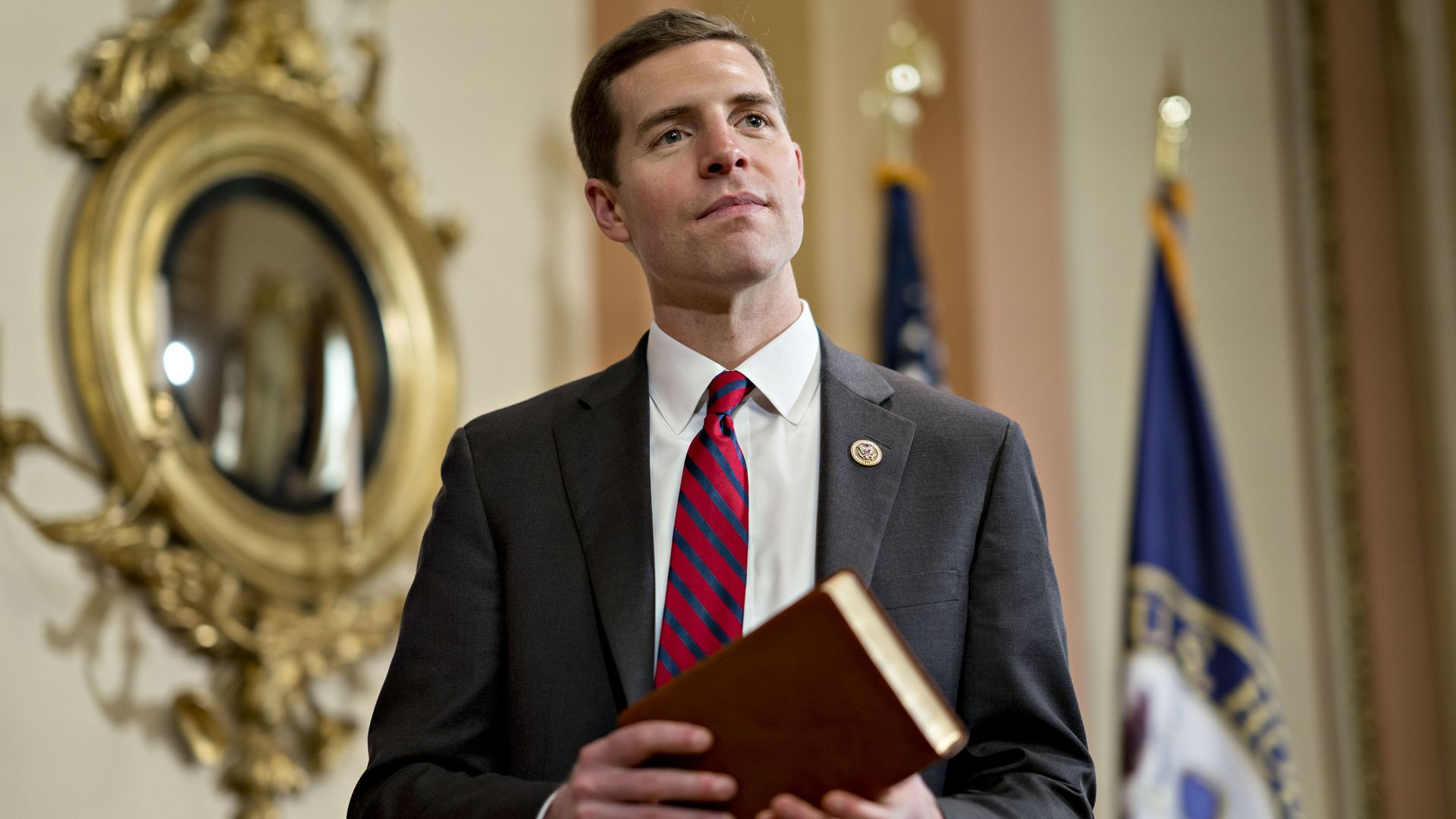 Rep. Conor Lamb is seen holding a Bible.