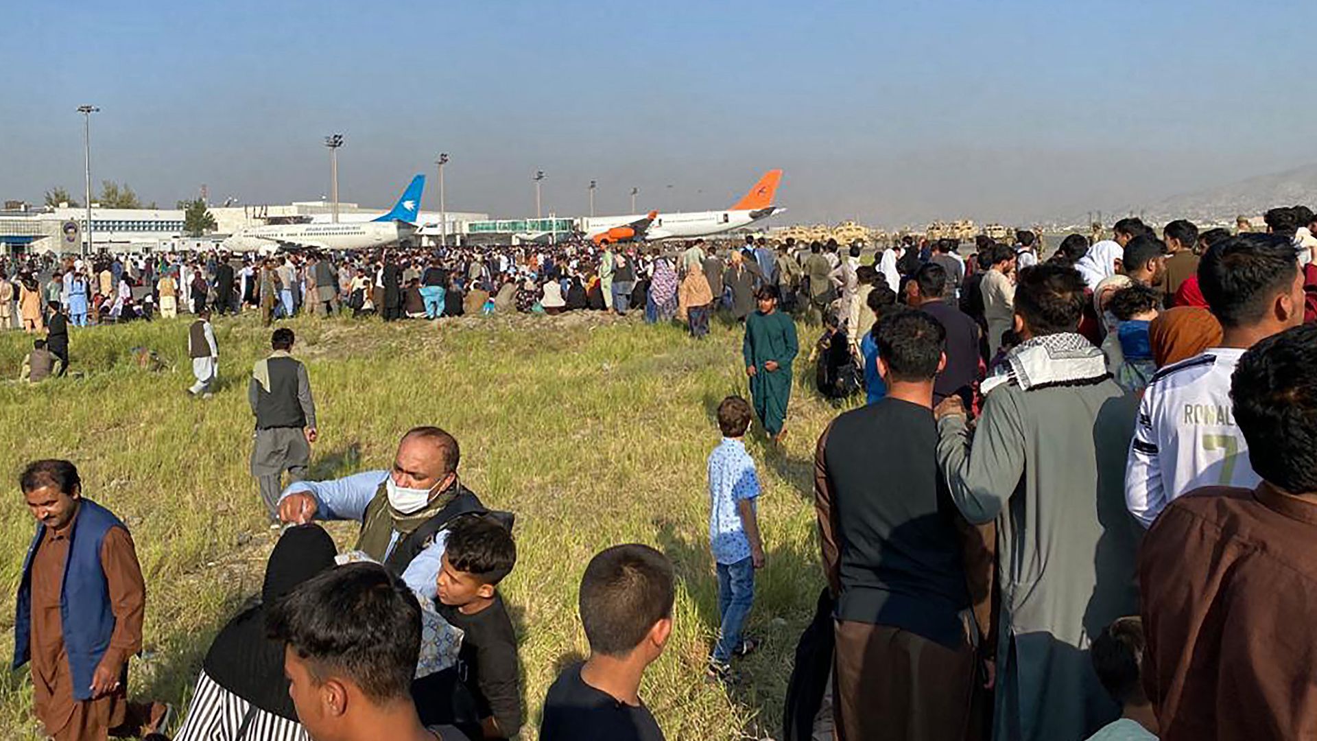 Afghan passengers crowd at Kabul's Hamid Karzai International Airport as they wait to leave the country on Aug. 16. 