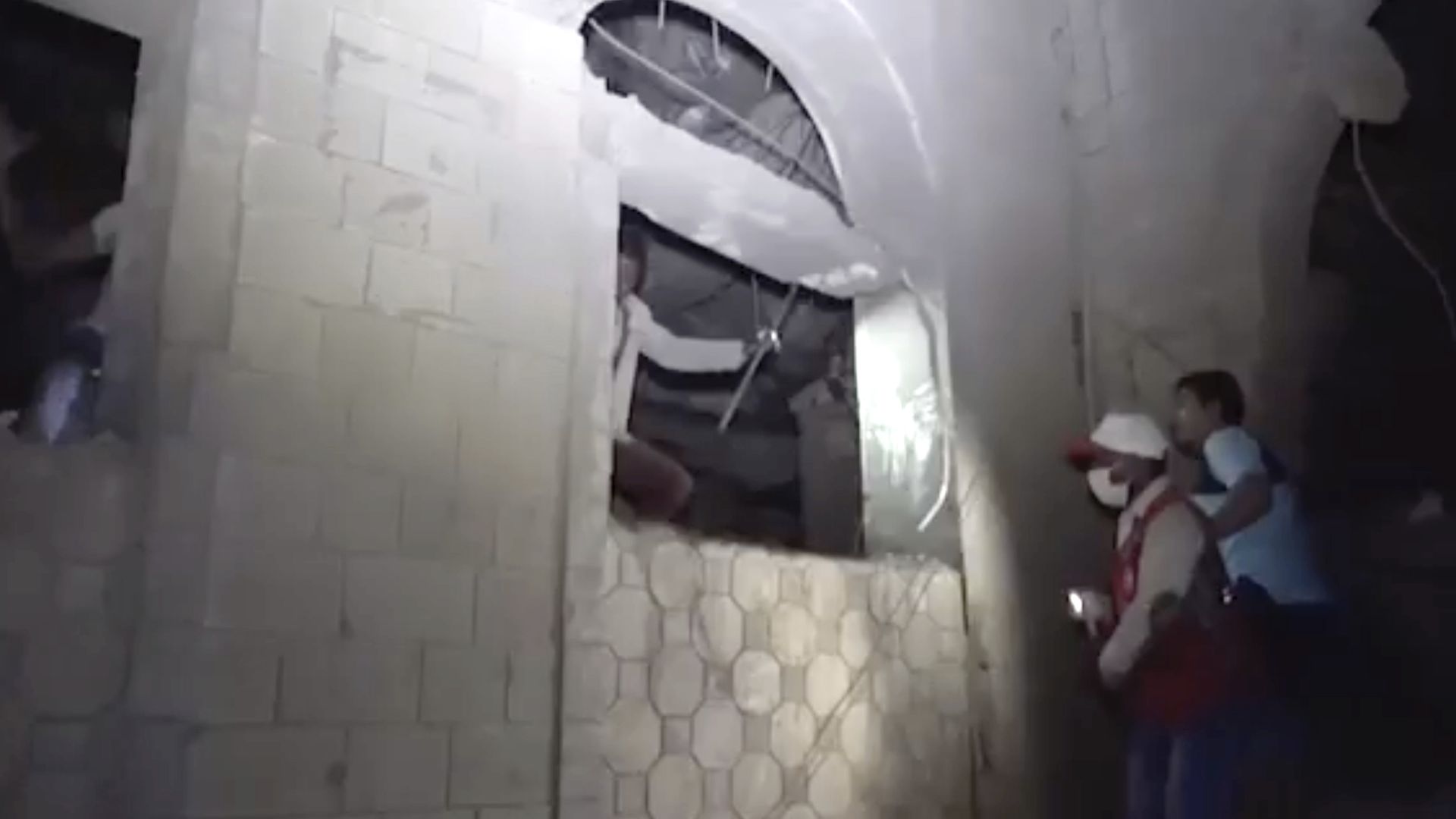 This photo provided by Ansar Allah Media Office, a man is rescued early Friday, Jan. 21, 2022, after Saudi-led airstrikes targeted a site in the contested city of Hodeida