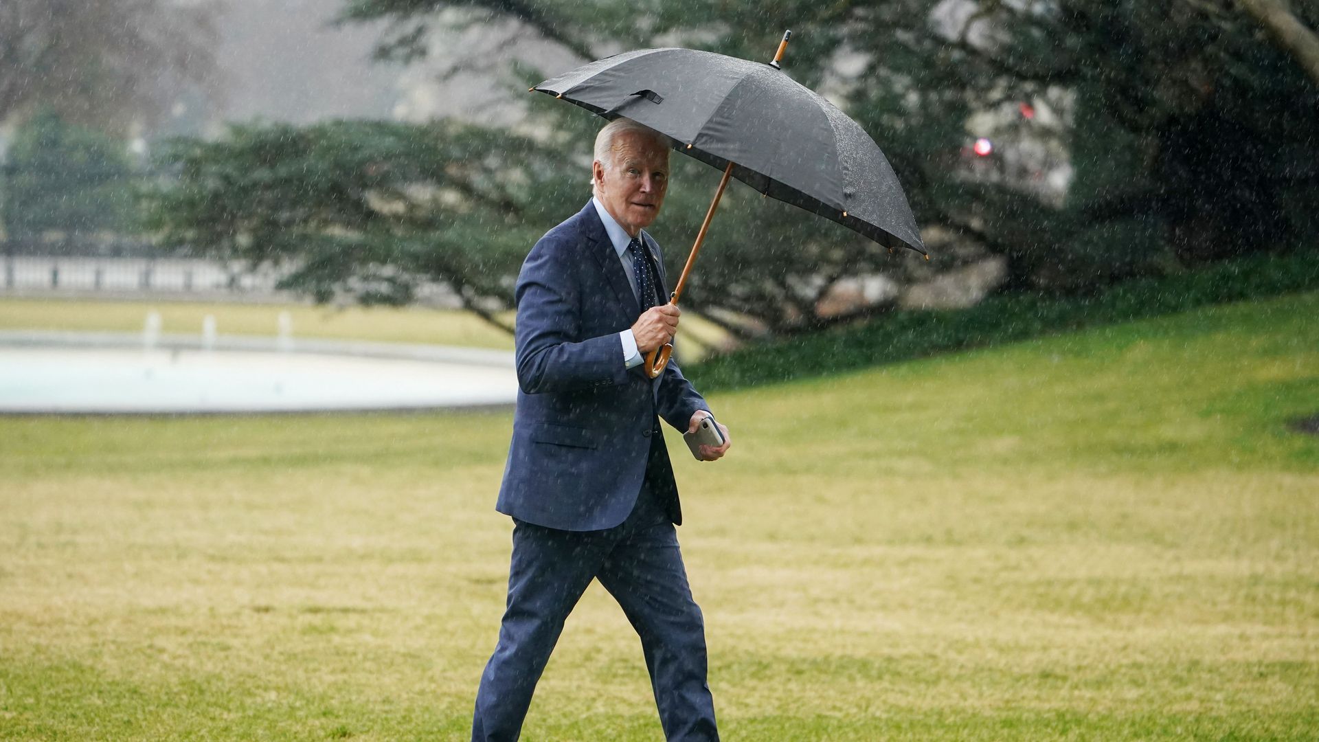 Biden carrying umbrella