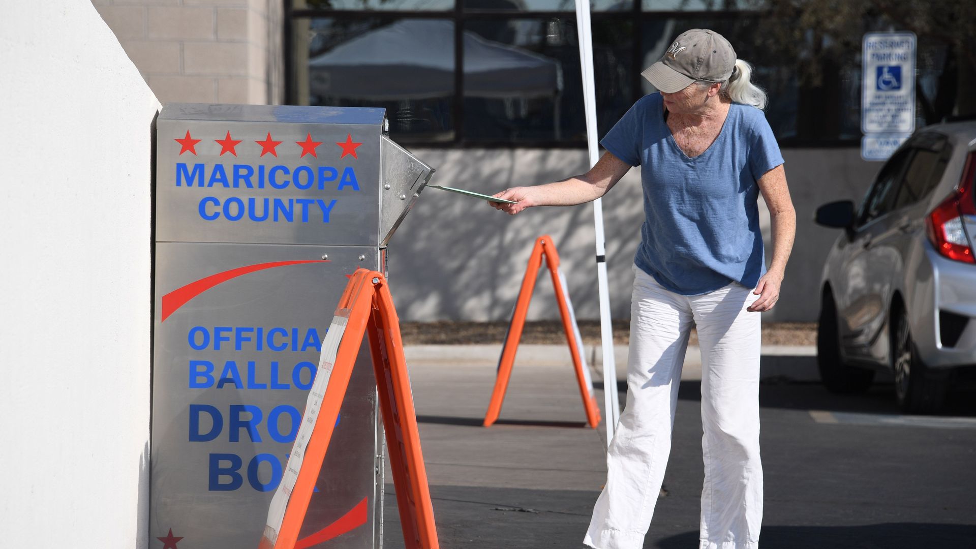 People deposit their mail-in ballots 