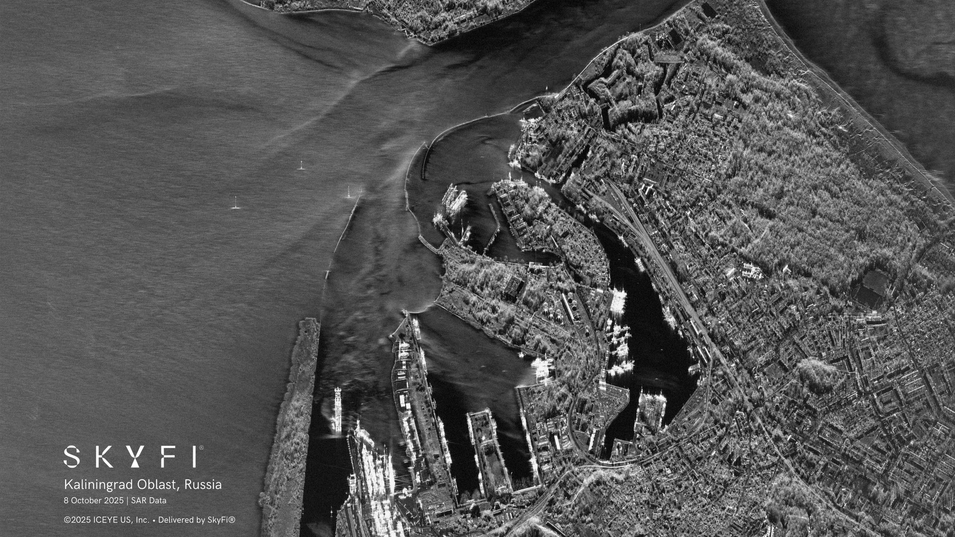 Black and white satellite radar image showing a detailed view of Kaliningrad Oblast, Russia, including docks, waterways, urban areas, and a fortified structure near the coast.