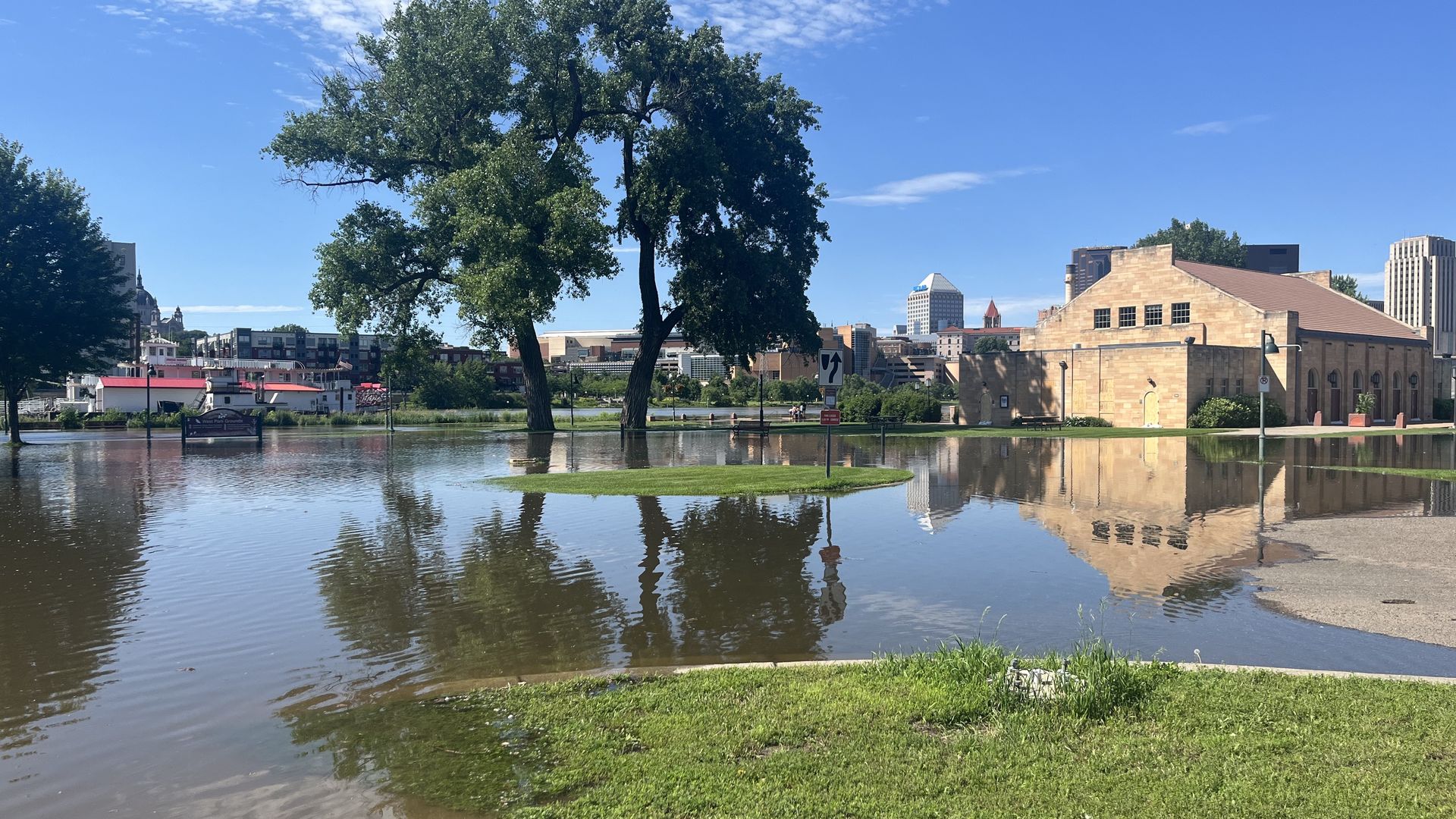 Water covers a street and comes close to a building on Harriet Island
