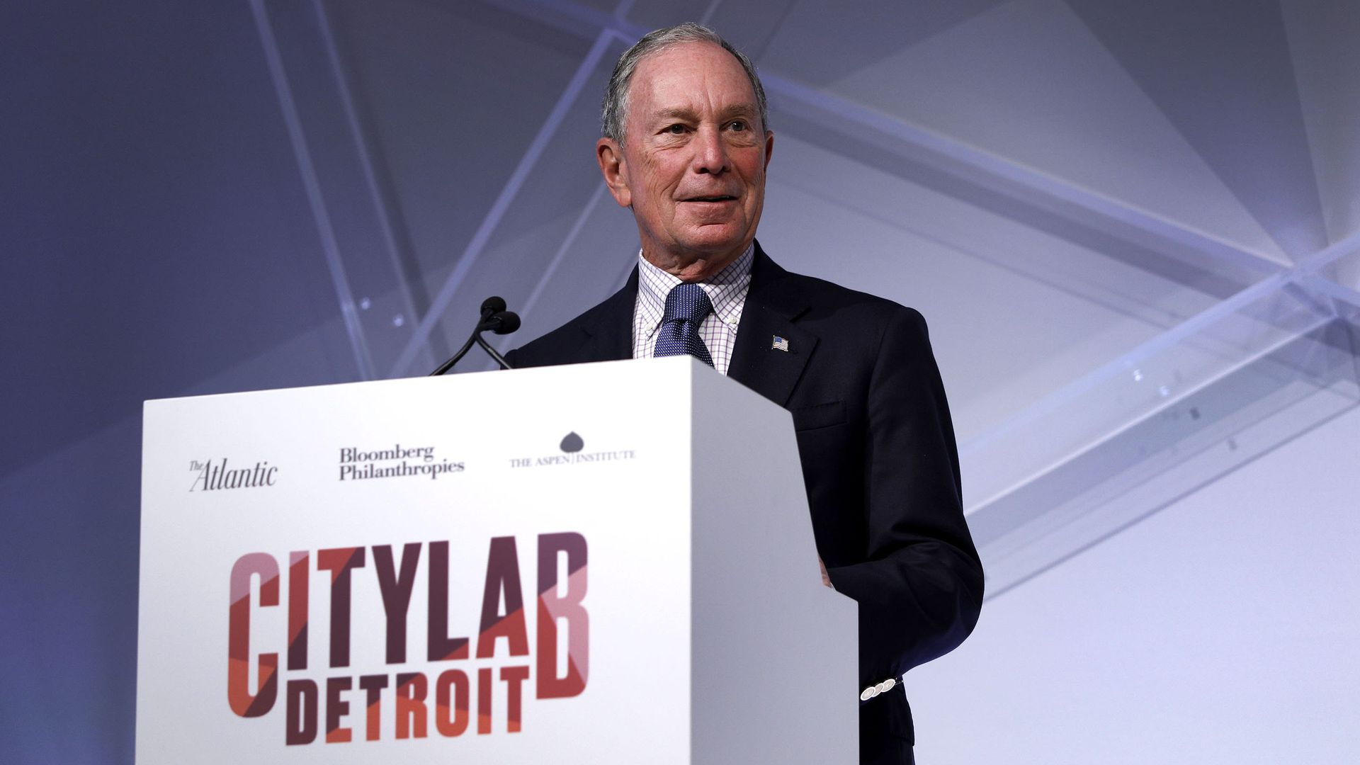 Michael Bloomberg behind a podium on stage