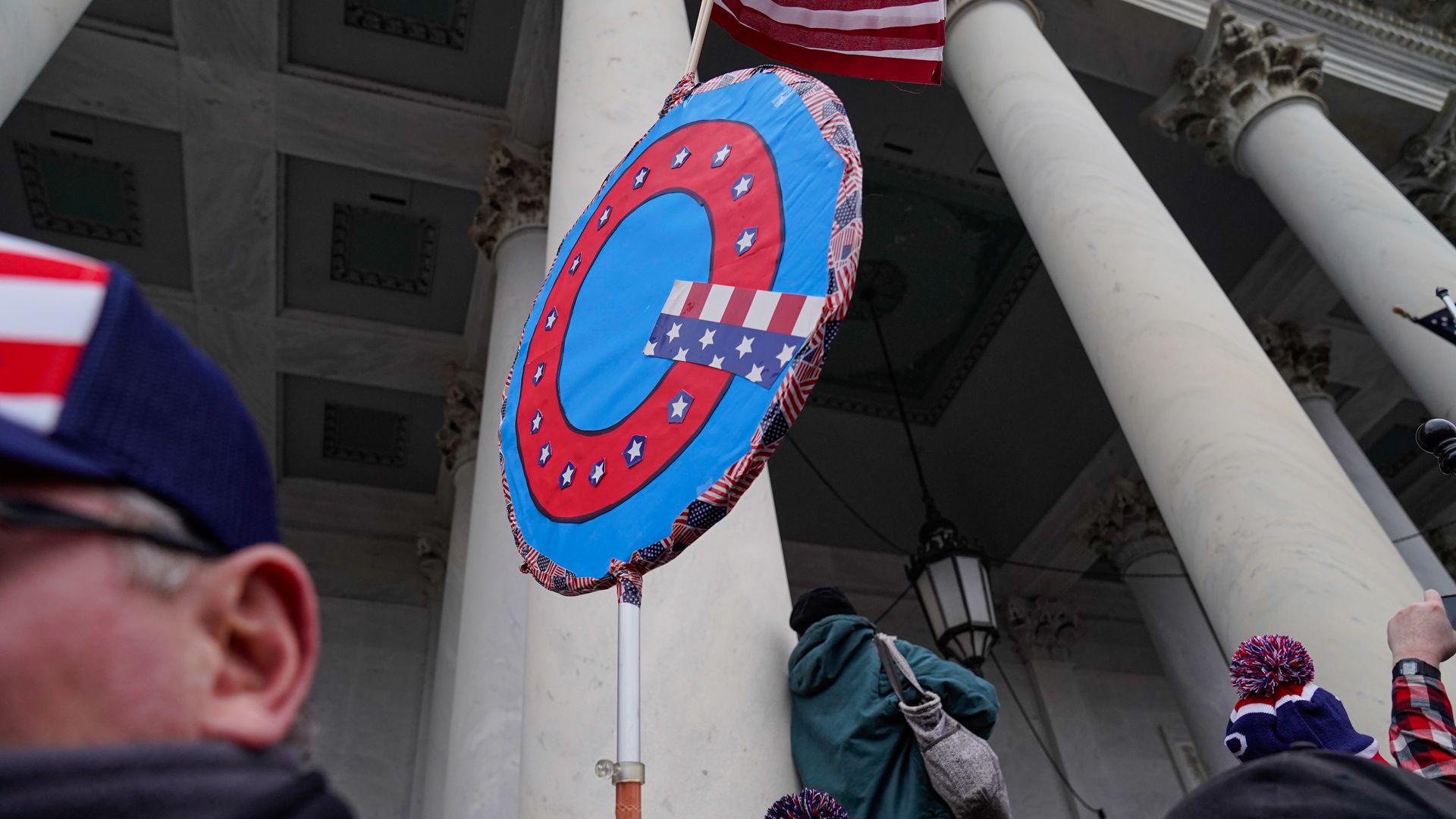 Crowds gather outside the U.S. Capitol for the "Stop the Steal" rally on January 06, 2021 with a Q sign