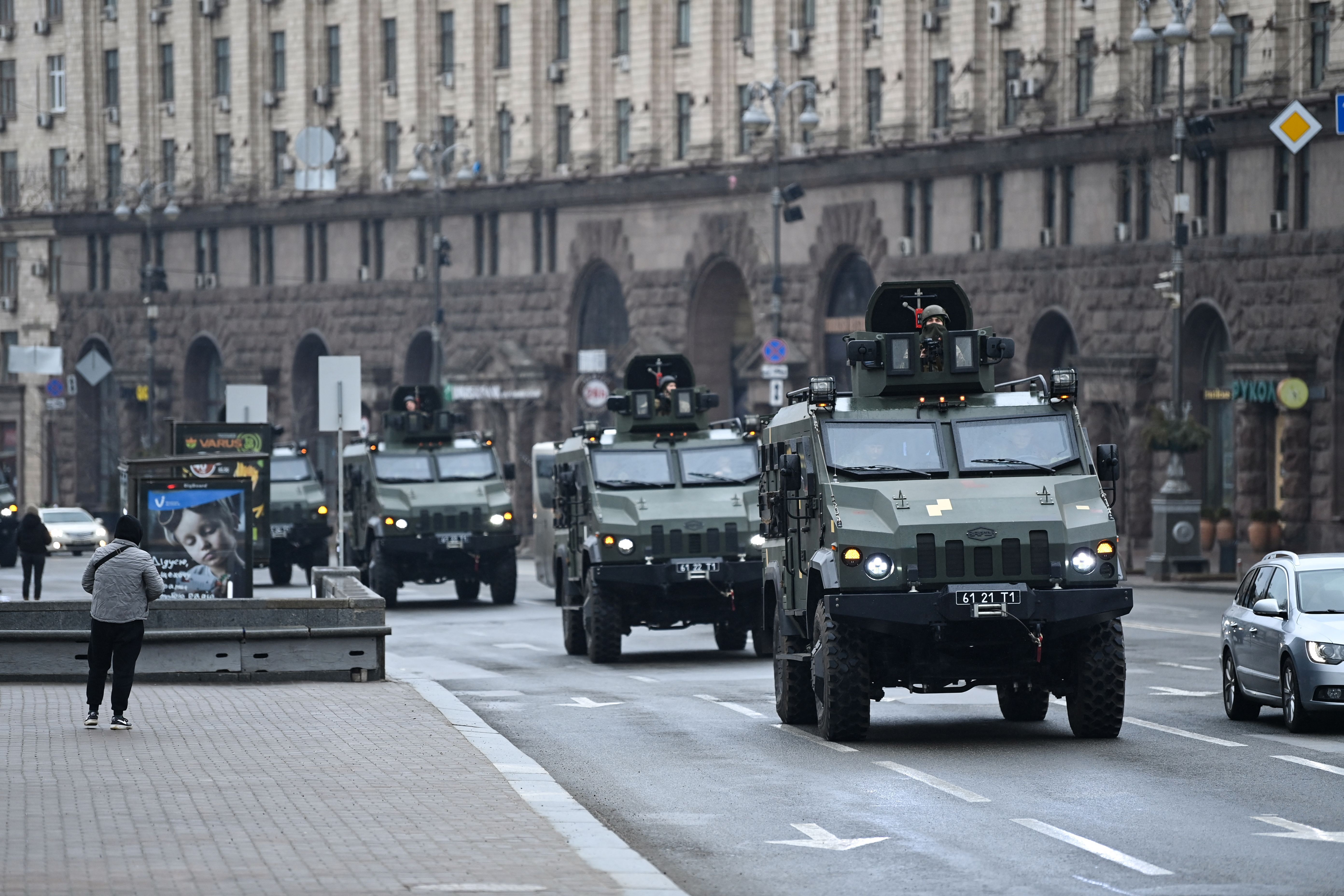 Ukrainian military vehicles move past Independence square in central Kyiv on Feb. 24.