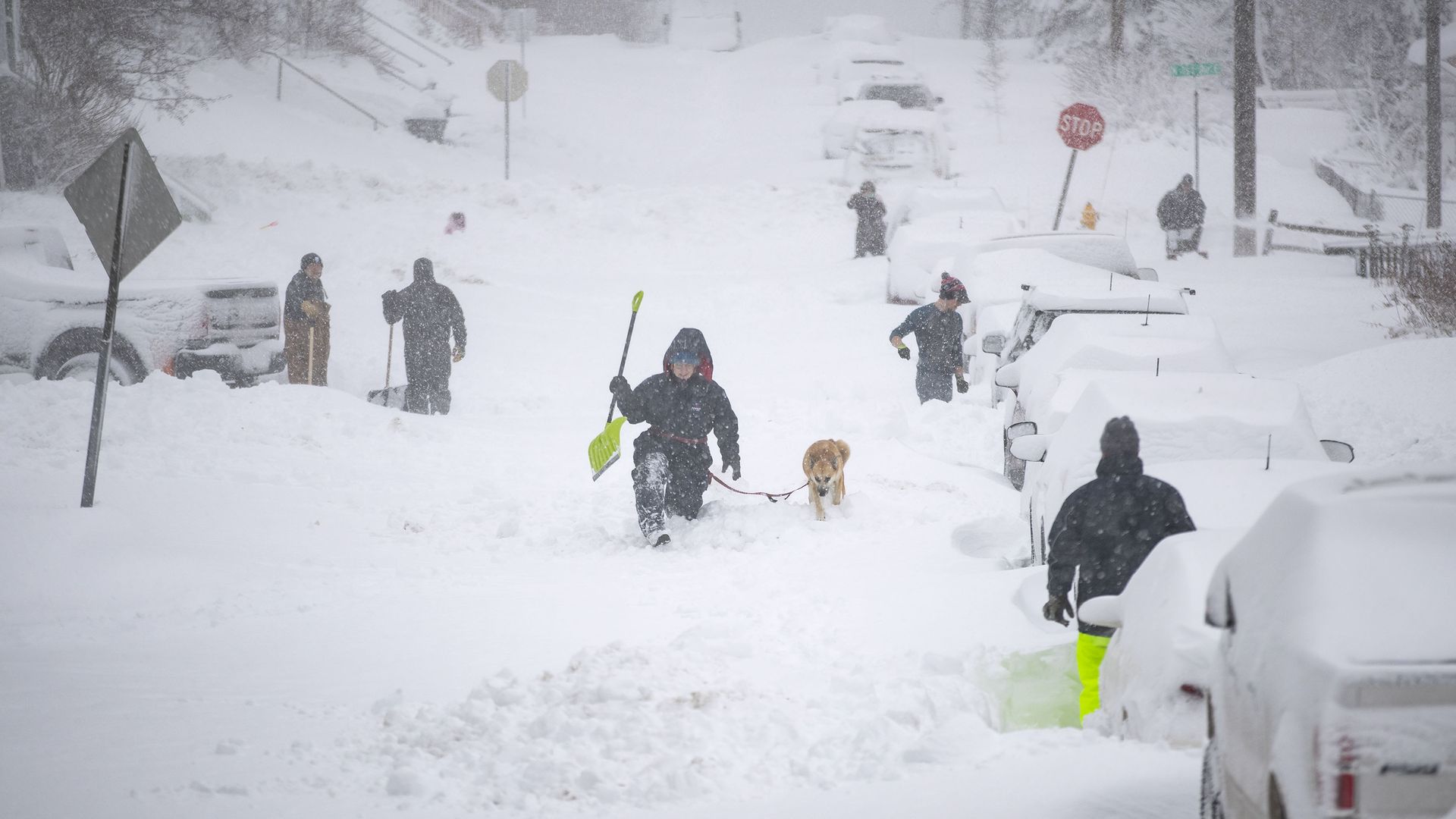 Neighbors worked together Sunday morning in an effort to clear out as much snow as possible from E. 8th St. in Duluth, Minnesota. 