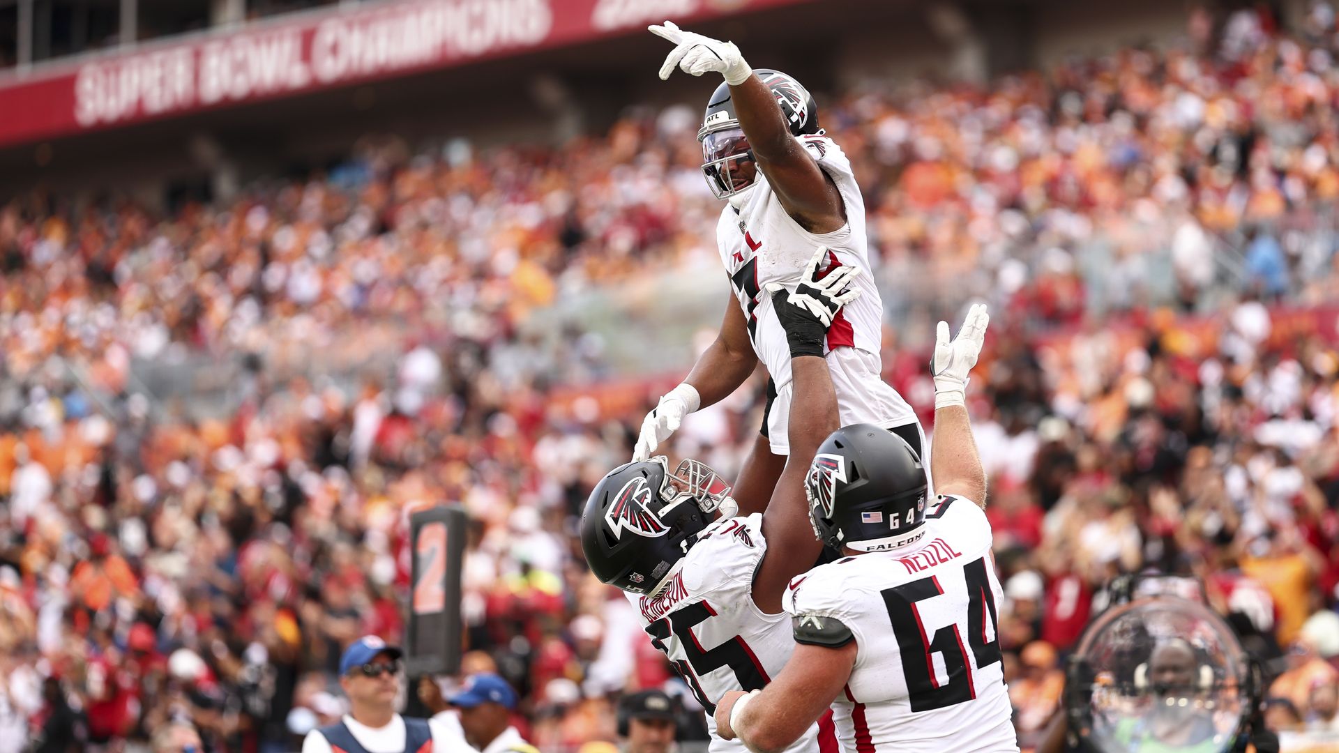 Falcons' Bijan Robinson and other teammates celebrate after Robinson scored a touchdown against the Tampa Bay Buccaneers. 