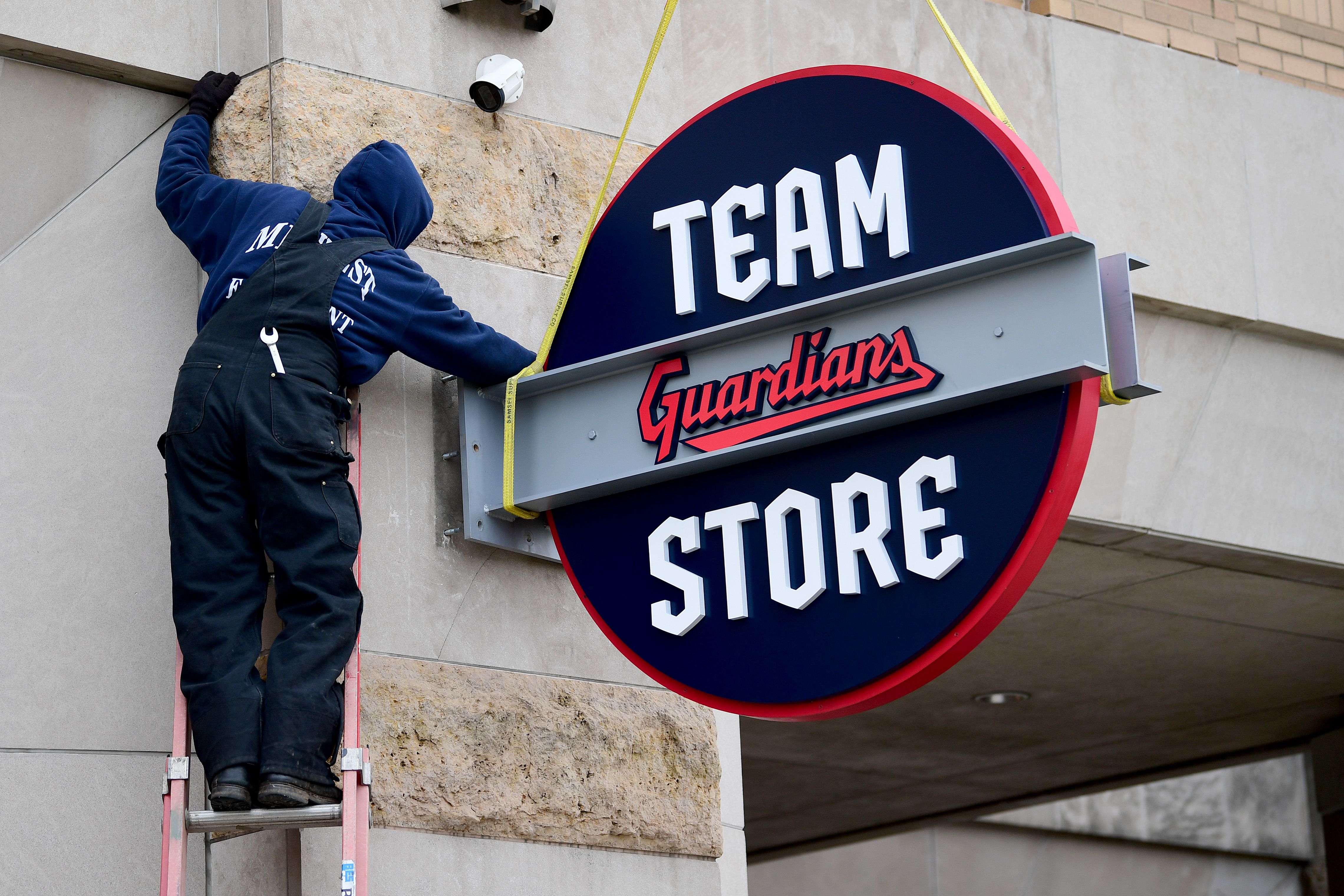 A worker installs the new "Guardians" team store sign in Cleveland. 