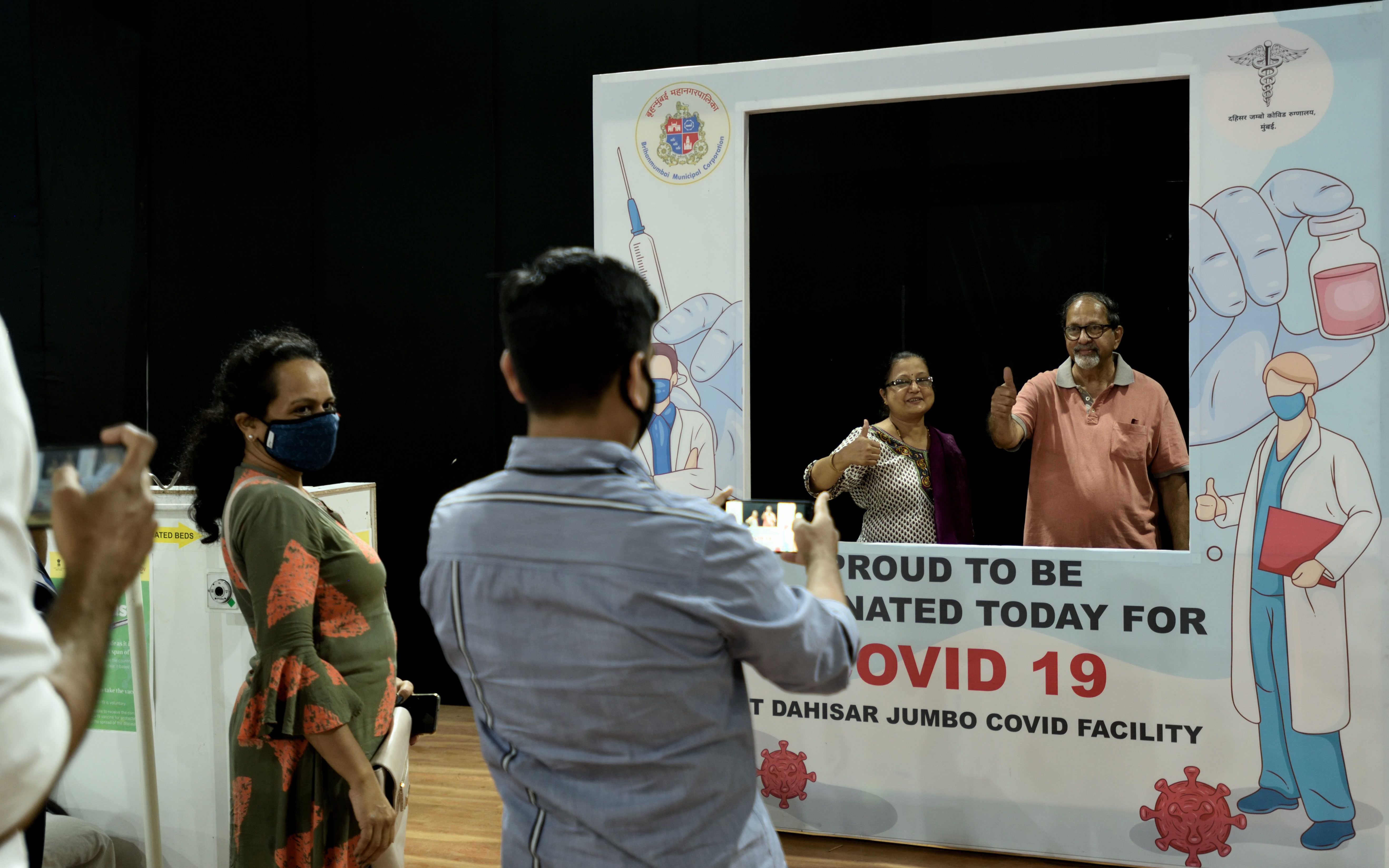  Senior citizens get photographed after being vaccinated against Covid-19 at Dahisar vaccine center on March 9, 2021 in Mumbai, India.