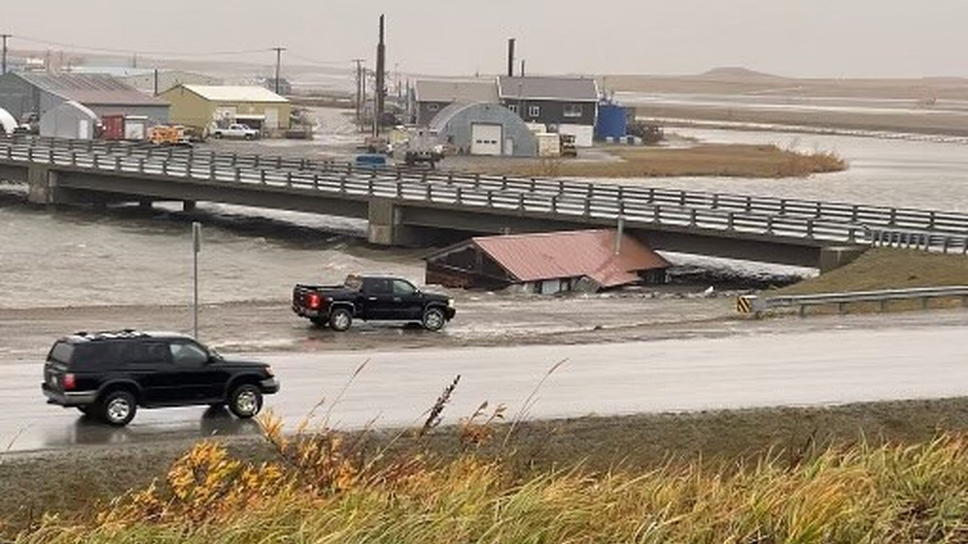 Photo of house stuck under Snake River bridge in Nome, Alaska.