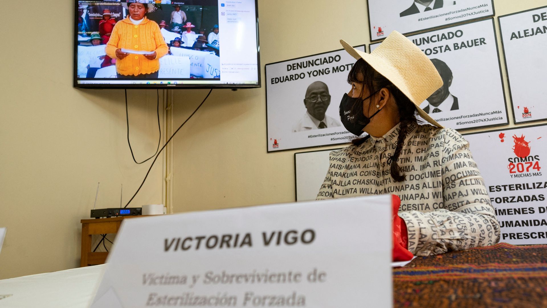 A victim of forced sterilization in Peru watches as another victim testifies. 