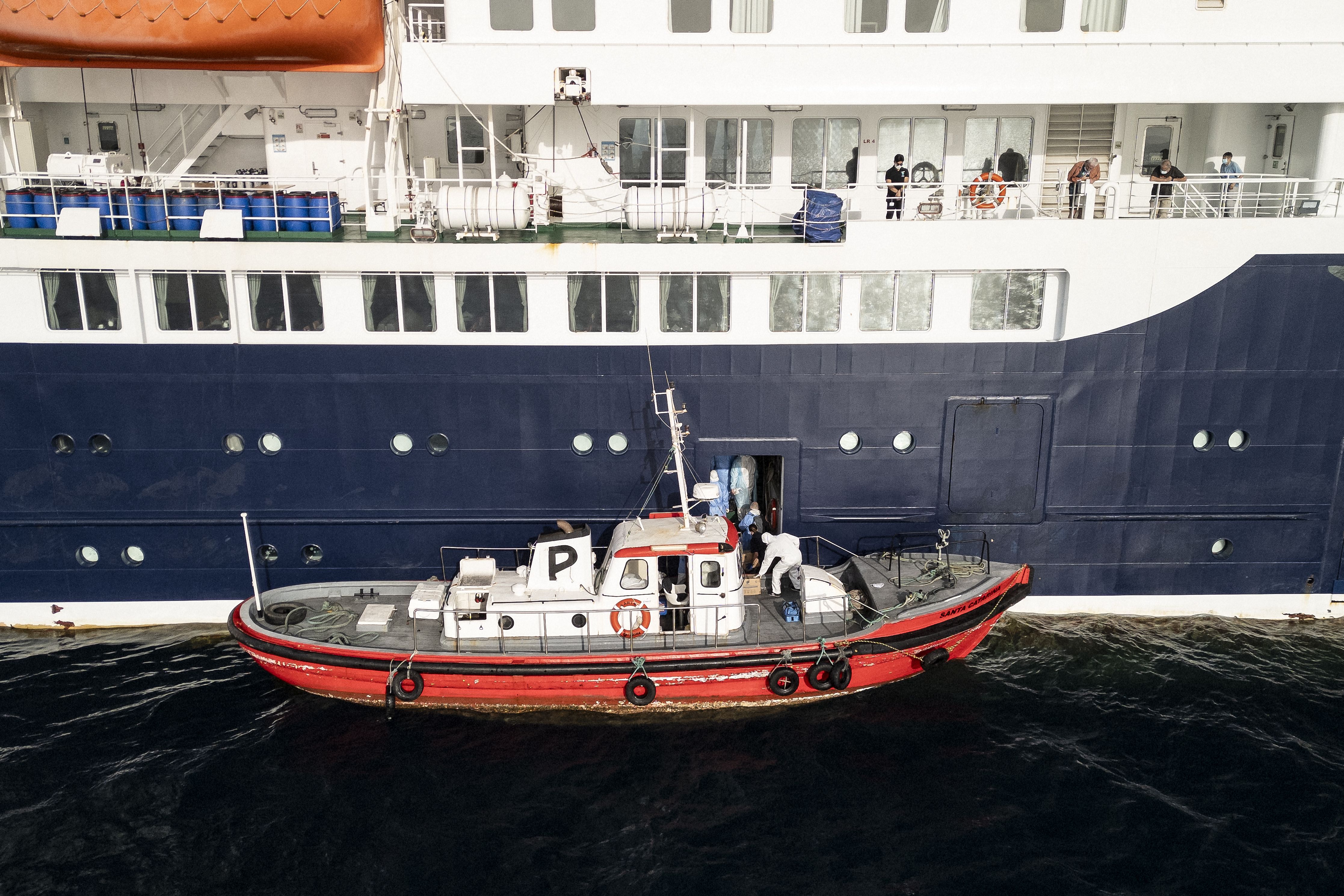 Health workers board the MV Hondius off Cape Verde, Africa, yesterday. Photo: AFP contributor via Getty Images