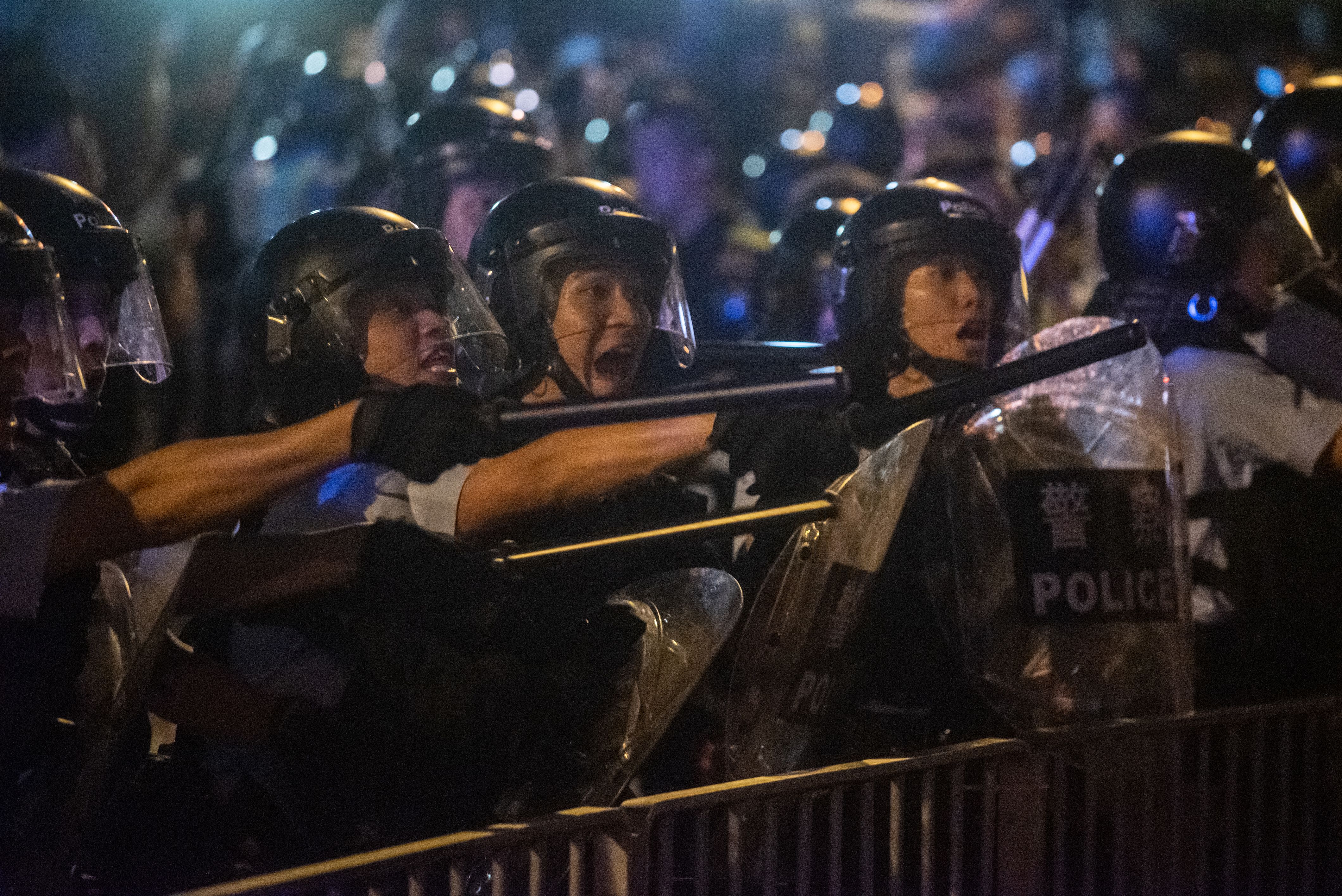 Riot police shout at protesters during clashes after a rally in Hong Kong.