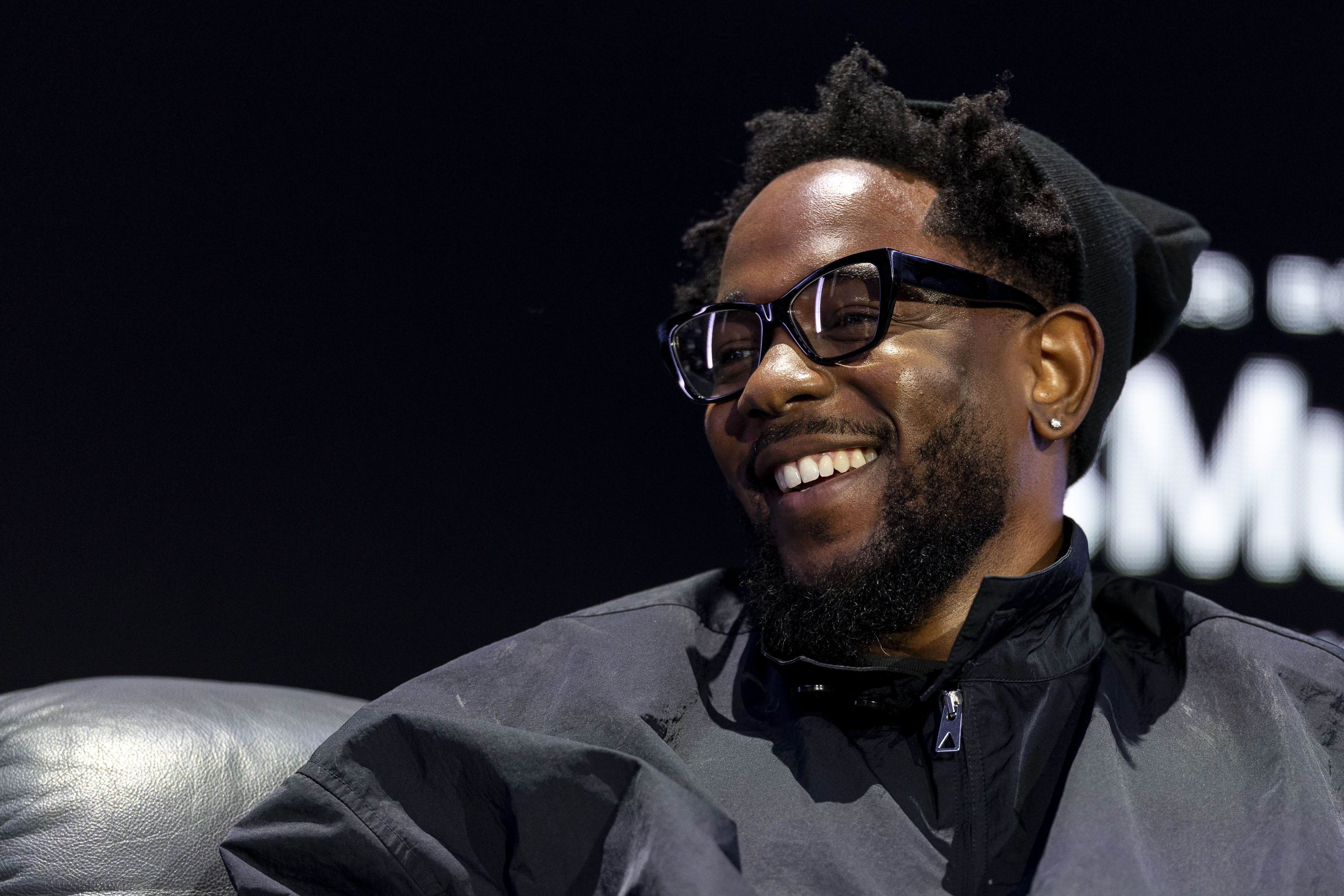 Kendrick Lamar smiles onstage at the Super Bowl LVIX Pregame & Apple Music Super Bowl LVIX Halftime Show Press Conference at Ernest N. Morial Convention Center on February 06, 2025 in New Orleans, Louisiana. (Photo by Michael Owens/Getty Images)