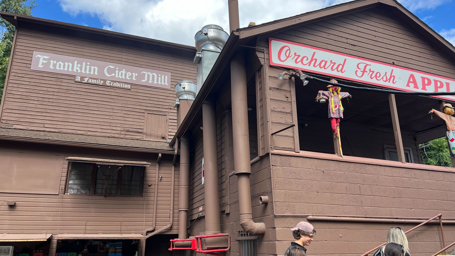 The brown Franklin Cider Mill building advertising fresh apples. 