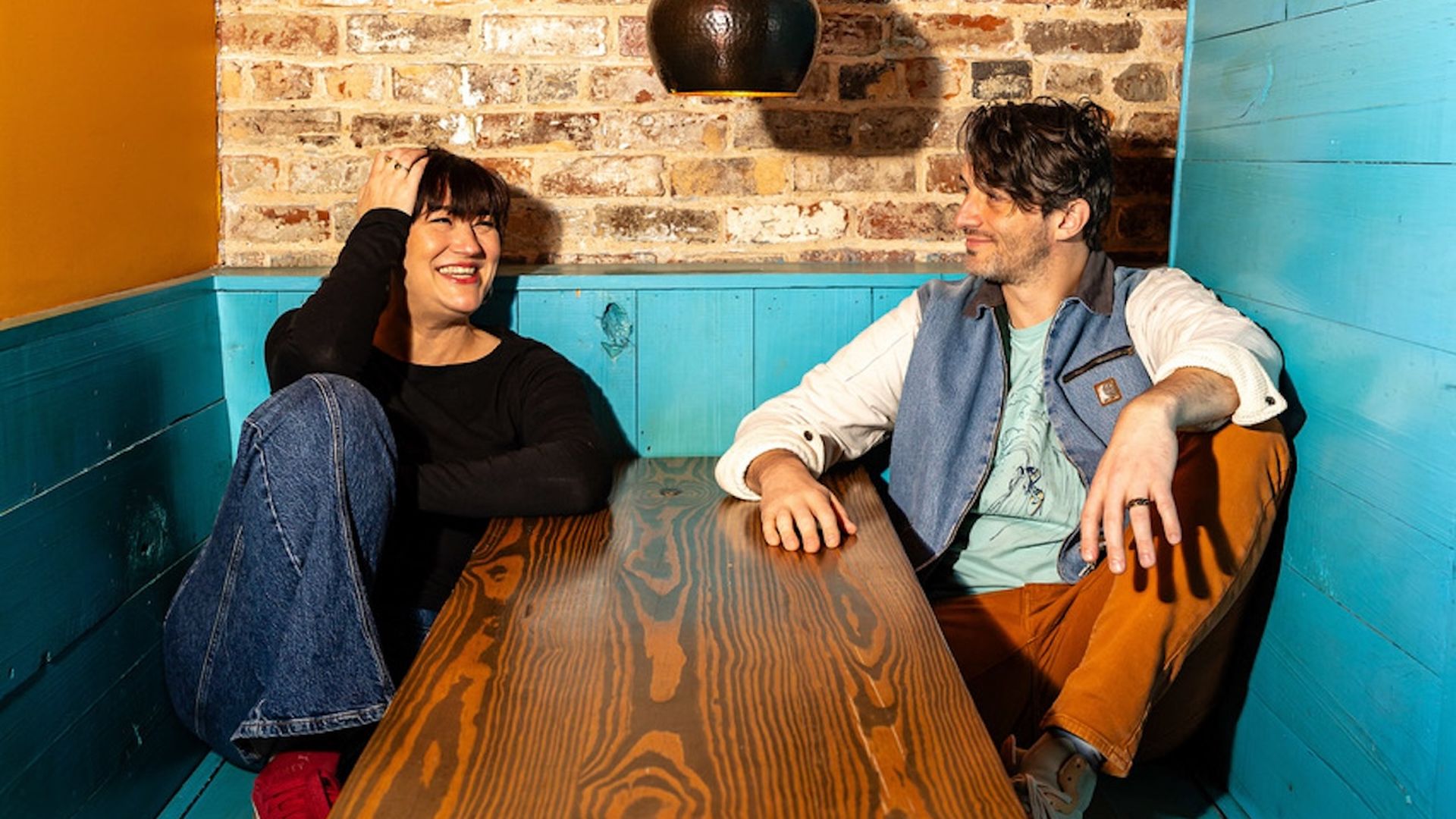 Two people sit at a bar table