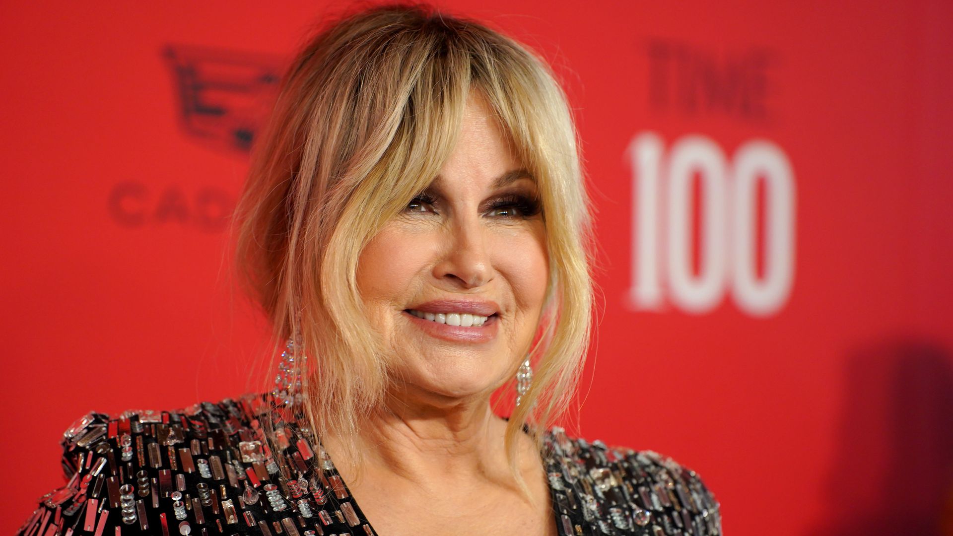 Photo shows Jennifer Coolidge smiling while on the red carpet