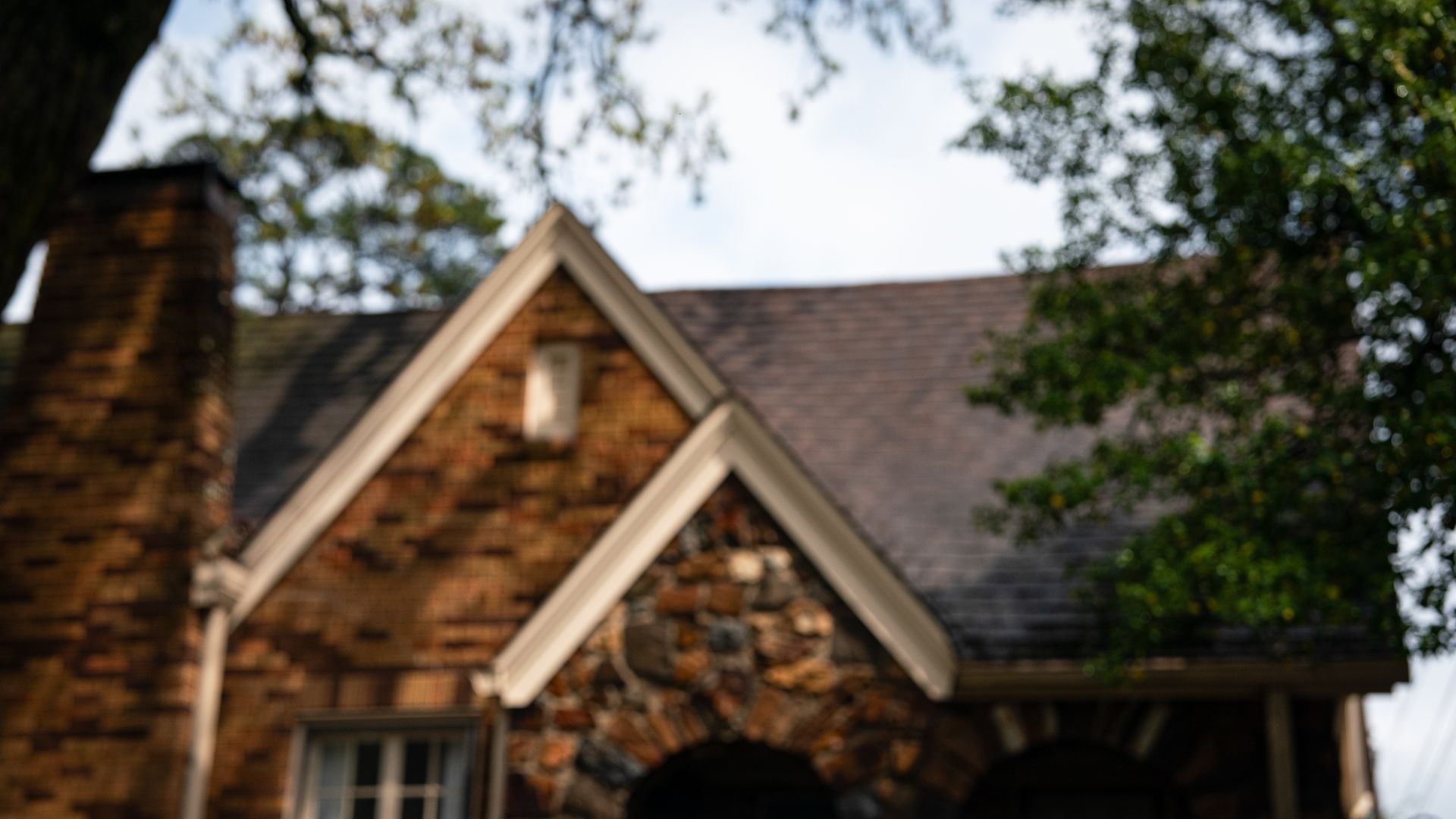 a brownstone home witha for sale sign