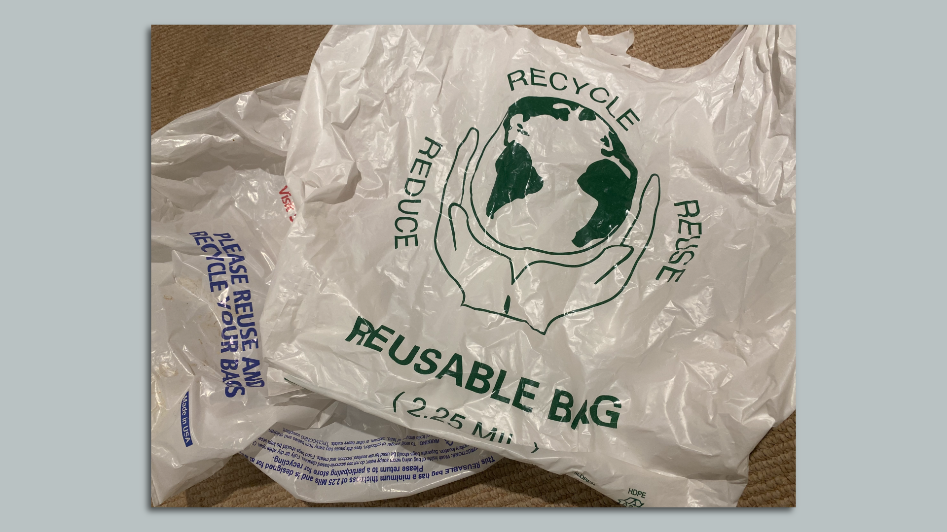 Several slightly crumpled reusable plastic shopping bags. 