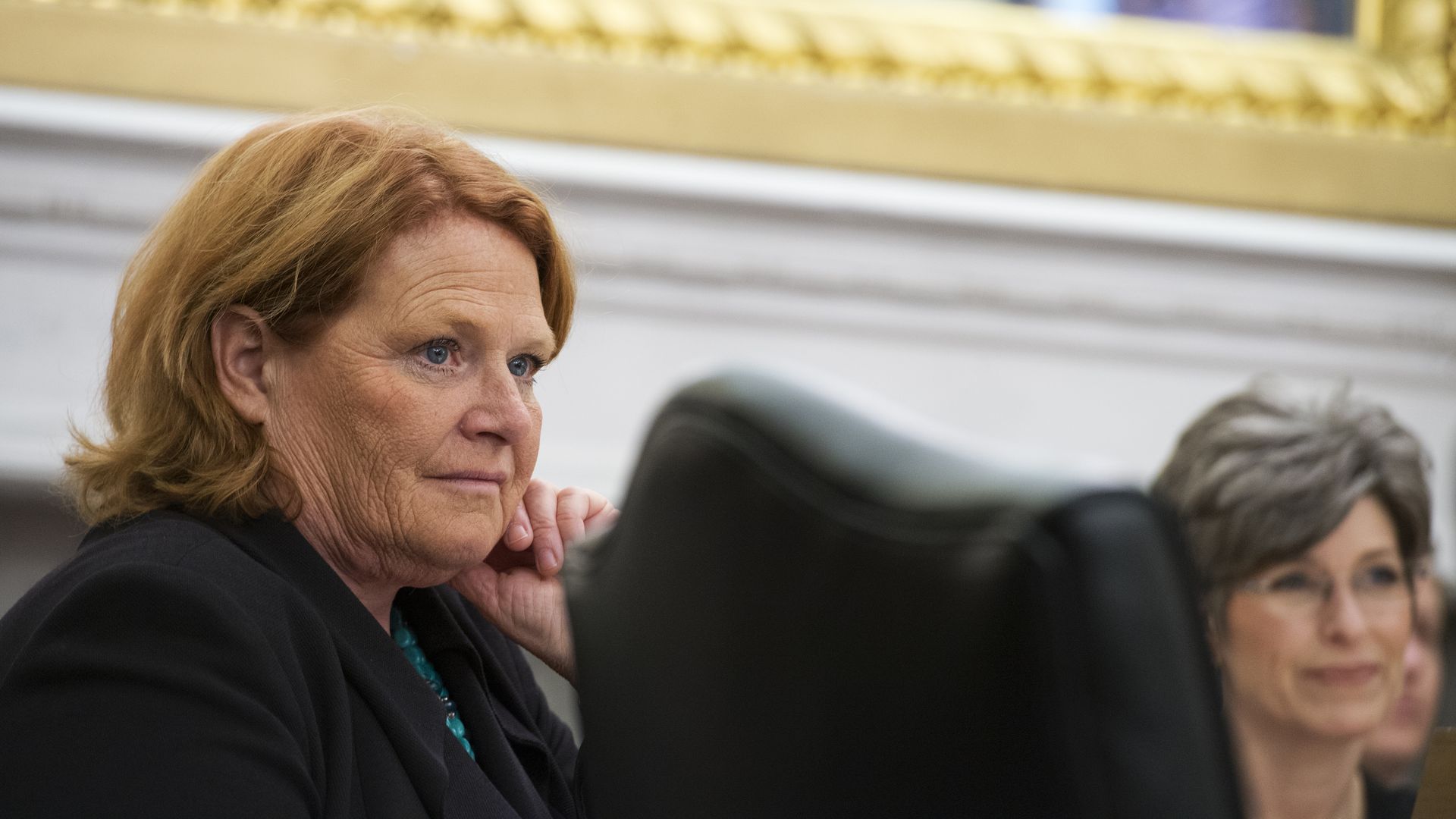 Heidi Heitkamp looking at someone with her hand on her cheek