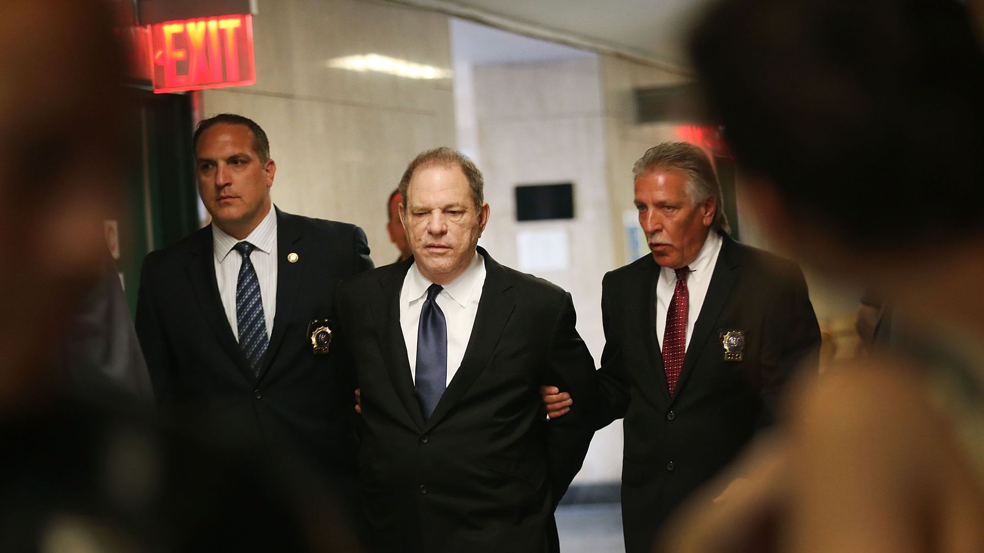 Harvey Weinstein being escorted in handcuffs