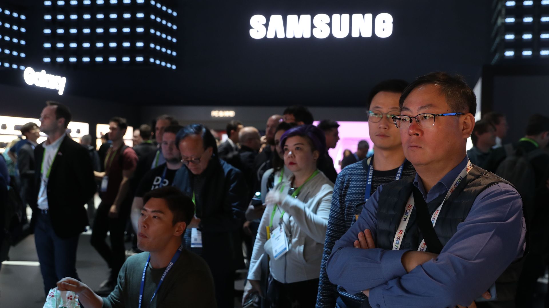 Attendees watch a presentation at the Samsung booth during a technology conference in 2019.