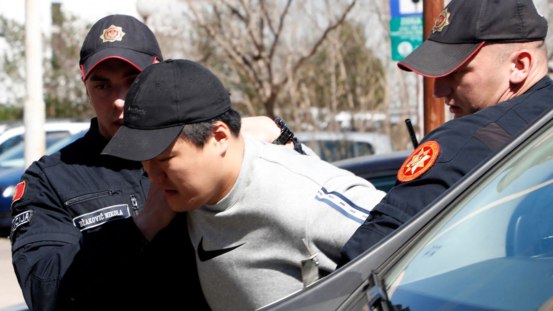 South Korean cryptocurrency entrepreneur and co-founder of Terraform Labs, Do Kwon, being escorted into court by two officers.
